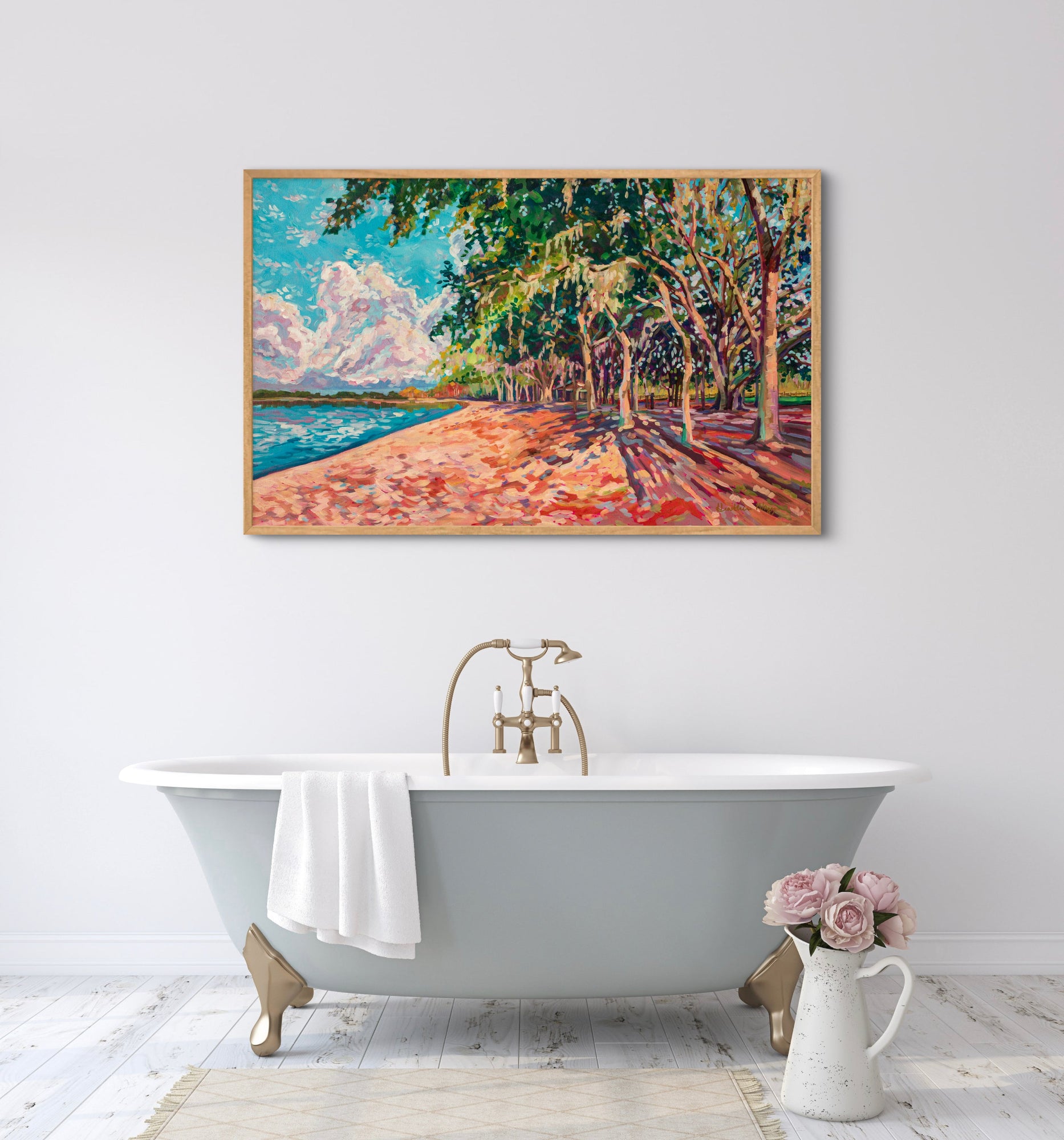 bathroom with traditional tub and dramatic landscape painting on wall above of peaceful park like scene.