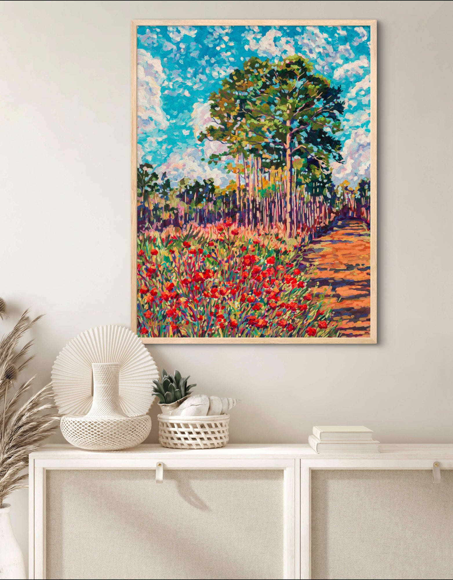 Colorful painting of an inviting trail in Split Oak Forest above a white bookshelf with neutral decor