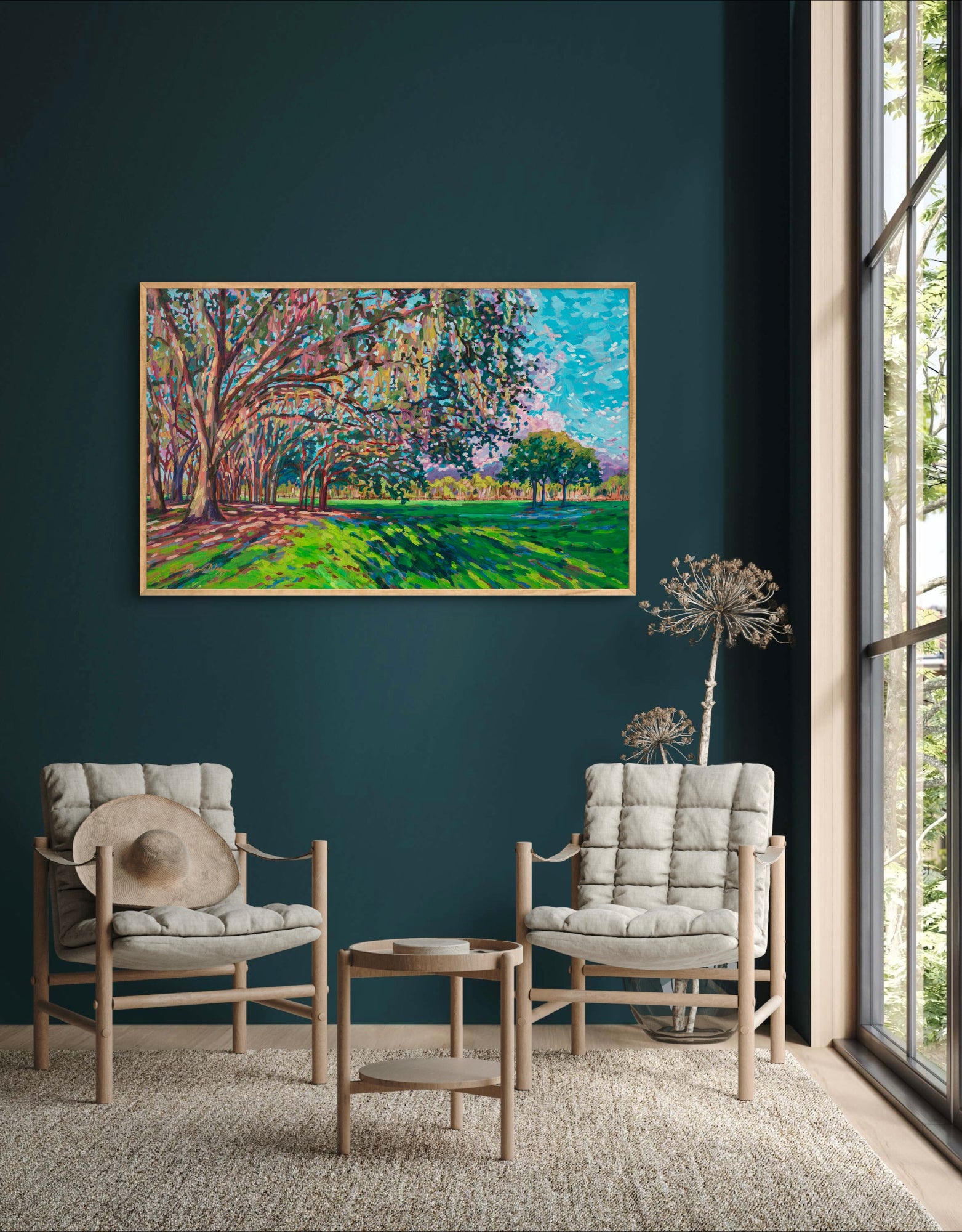 Natural Landscape painting of Chisholm park in South East Orlando off Narccoossee Rd  in sitting room with dark blue green walls and  neutral chairs, table and rug by window