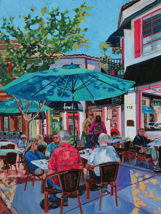 Quaint stylish Park Ave Winter Park scene of people enjoying a morning coffee outside under umbrellas near Barney's coffee.