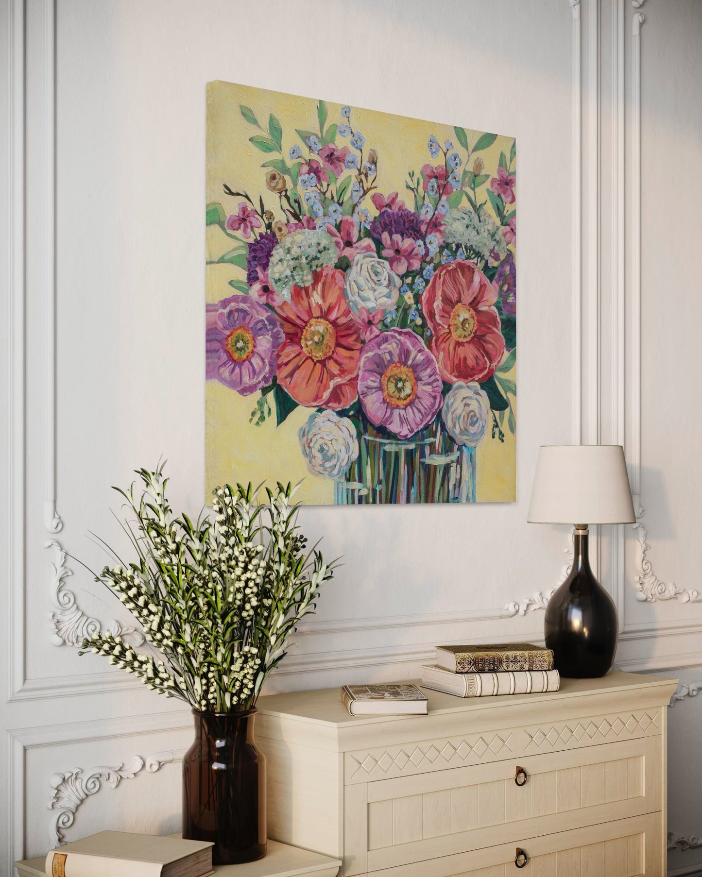 Floral painting on a wall above a dresser with decorative items.