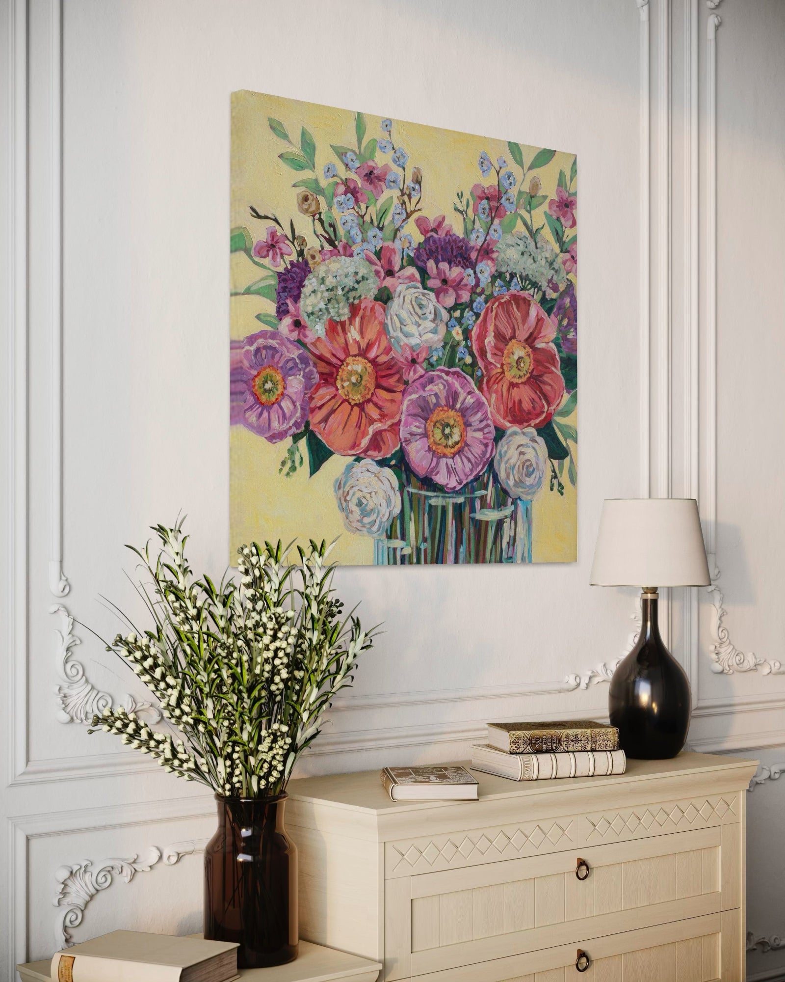 Floral painting on a wall above a dresser with decorative items.