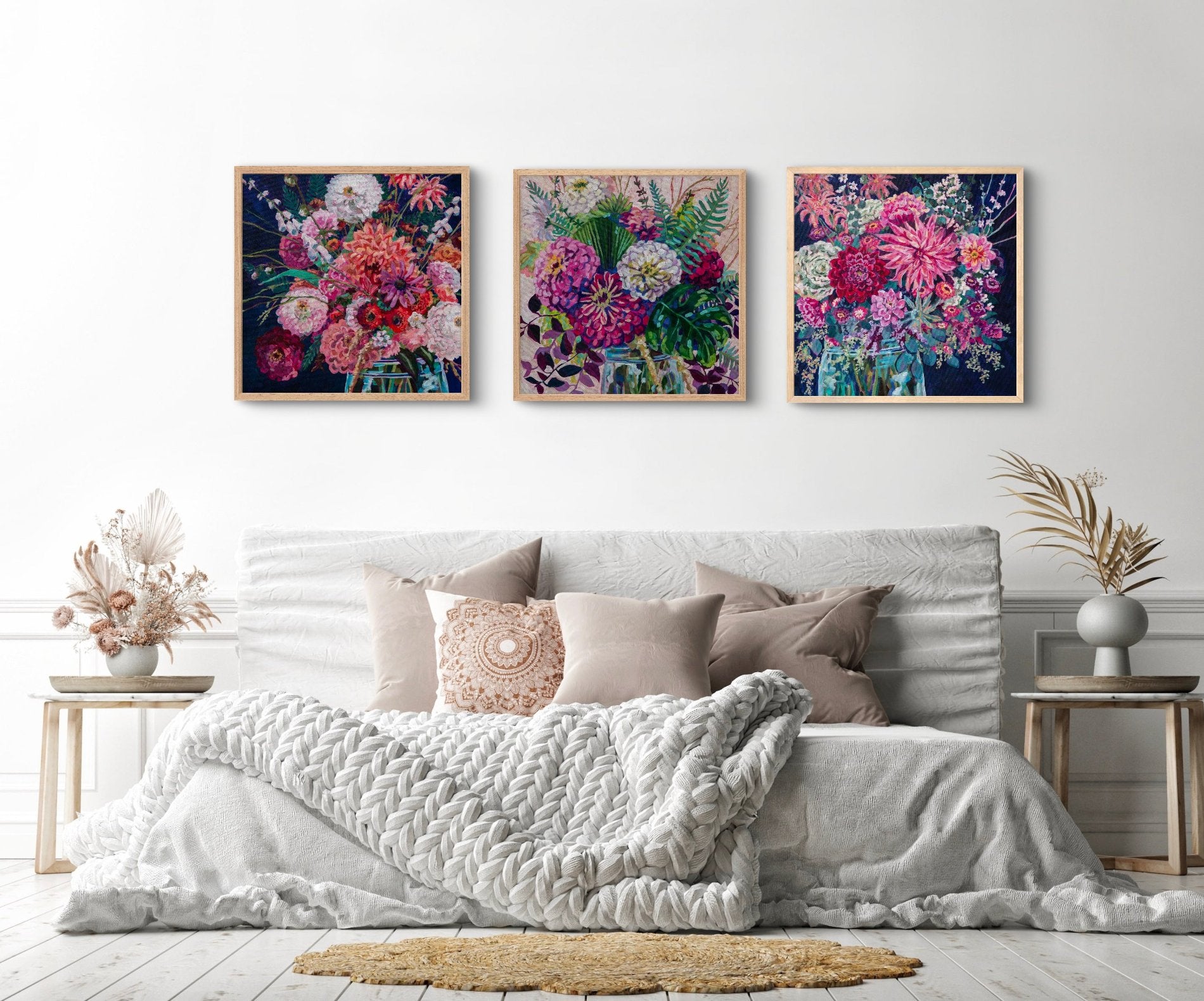 Neutral airy but cozy bedroom  with two side tables with dried plants and three amazing statement piece floral still life paintings by artist Heather Nagy
