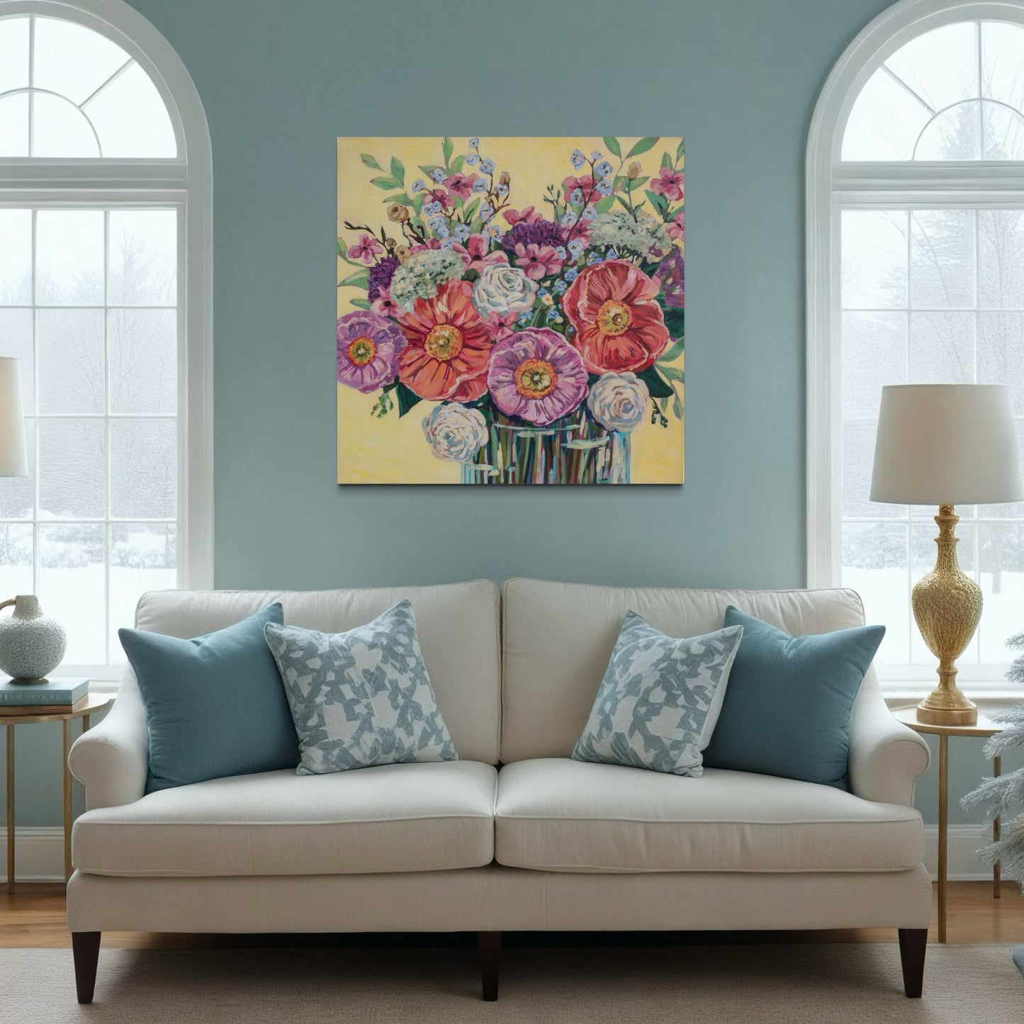Living room with a beige sofa, floral painting on the wall, and decorative pillows.