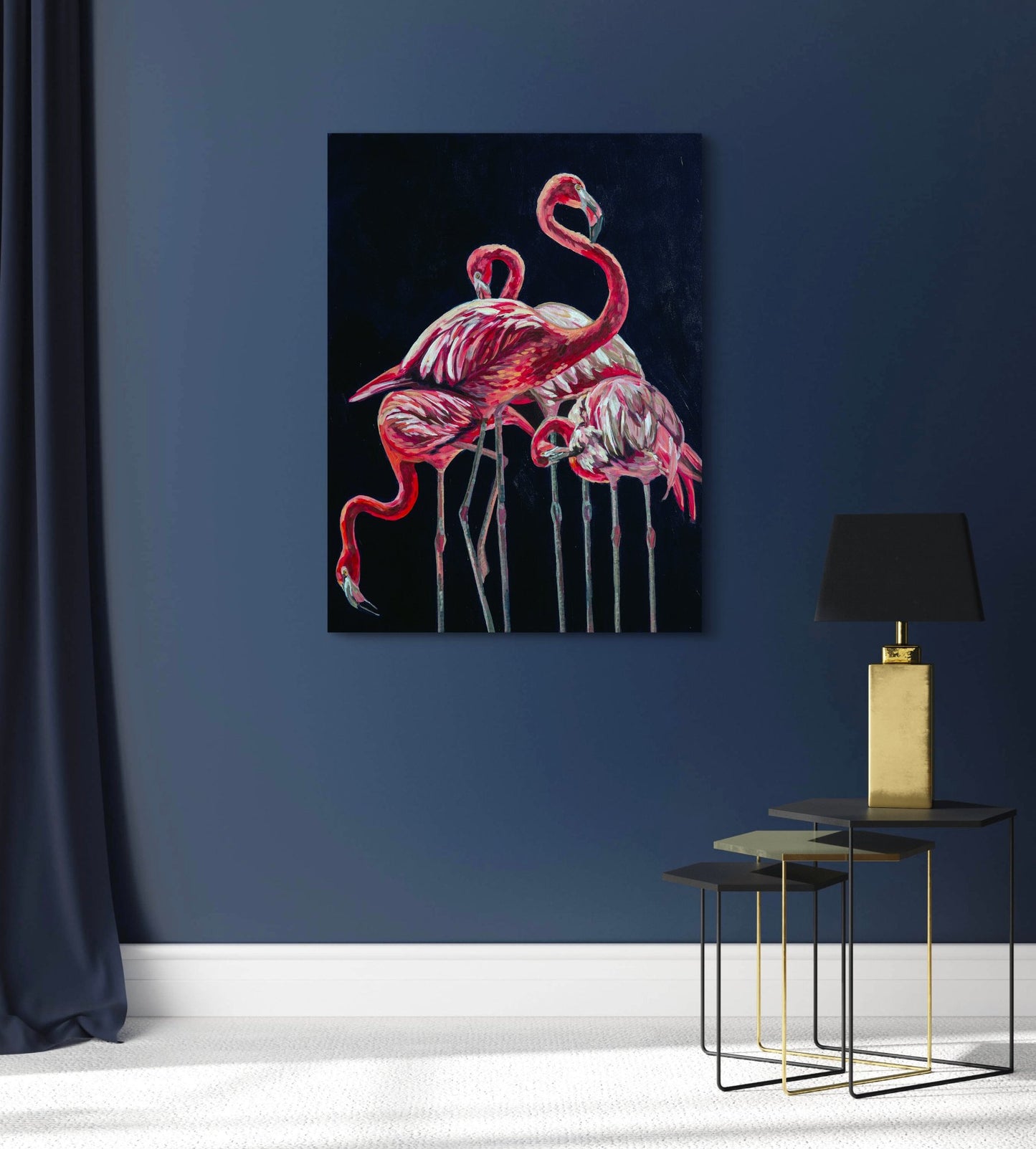 Dramatic painterly impressionist flamingos painting in room with navy walls and metal side table and lamp.