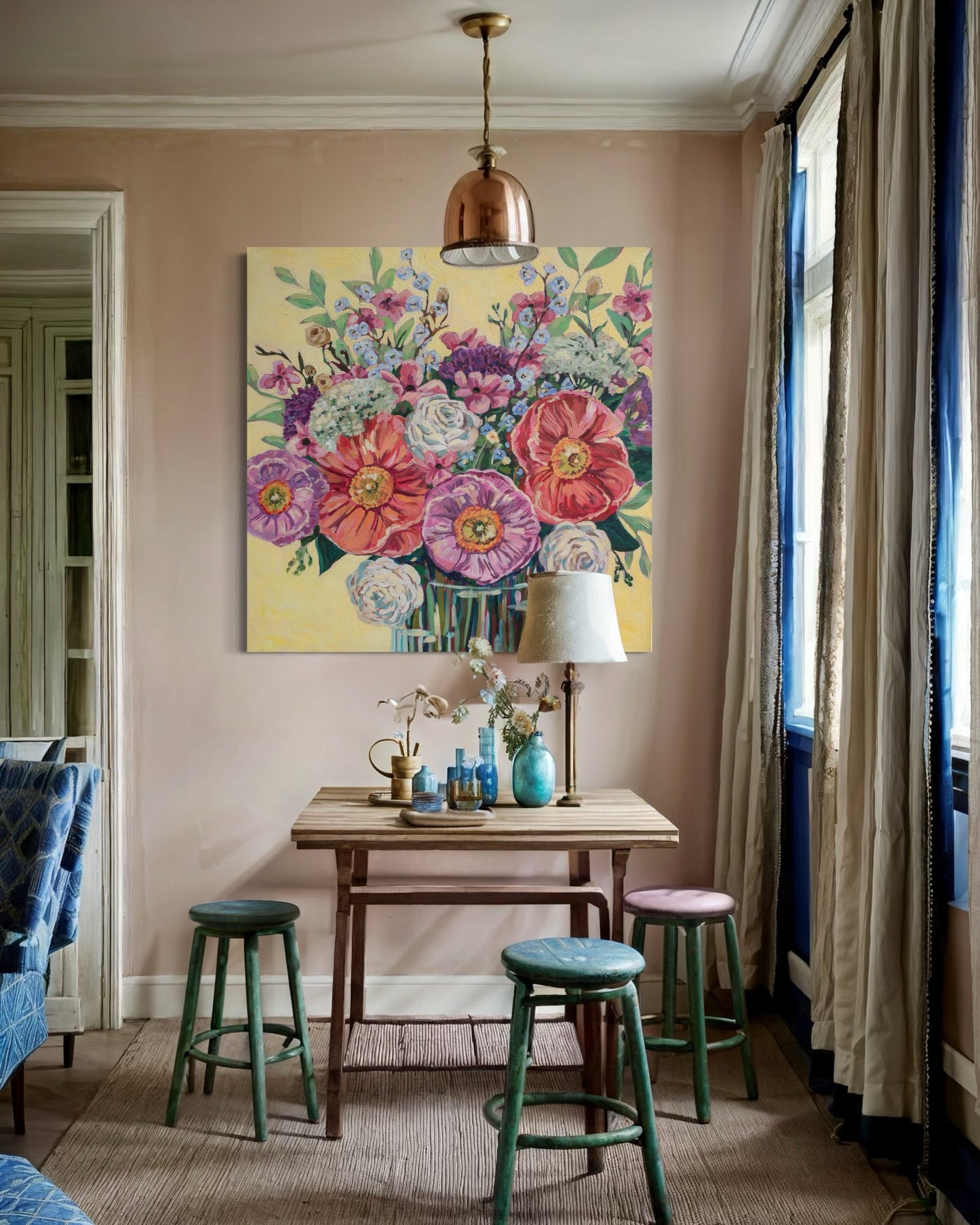 Room interior with a floral painting on the wall, wooden table with decor items, and colorful stools.