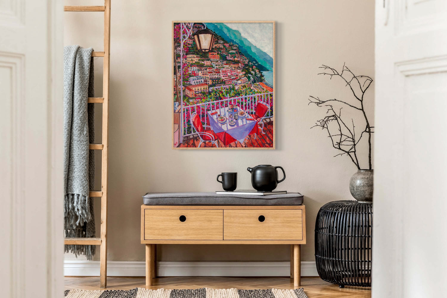 Foyer of house with vibrant painting of balonly overlooking Positano Italy