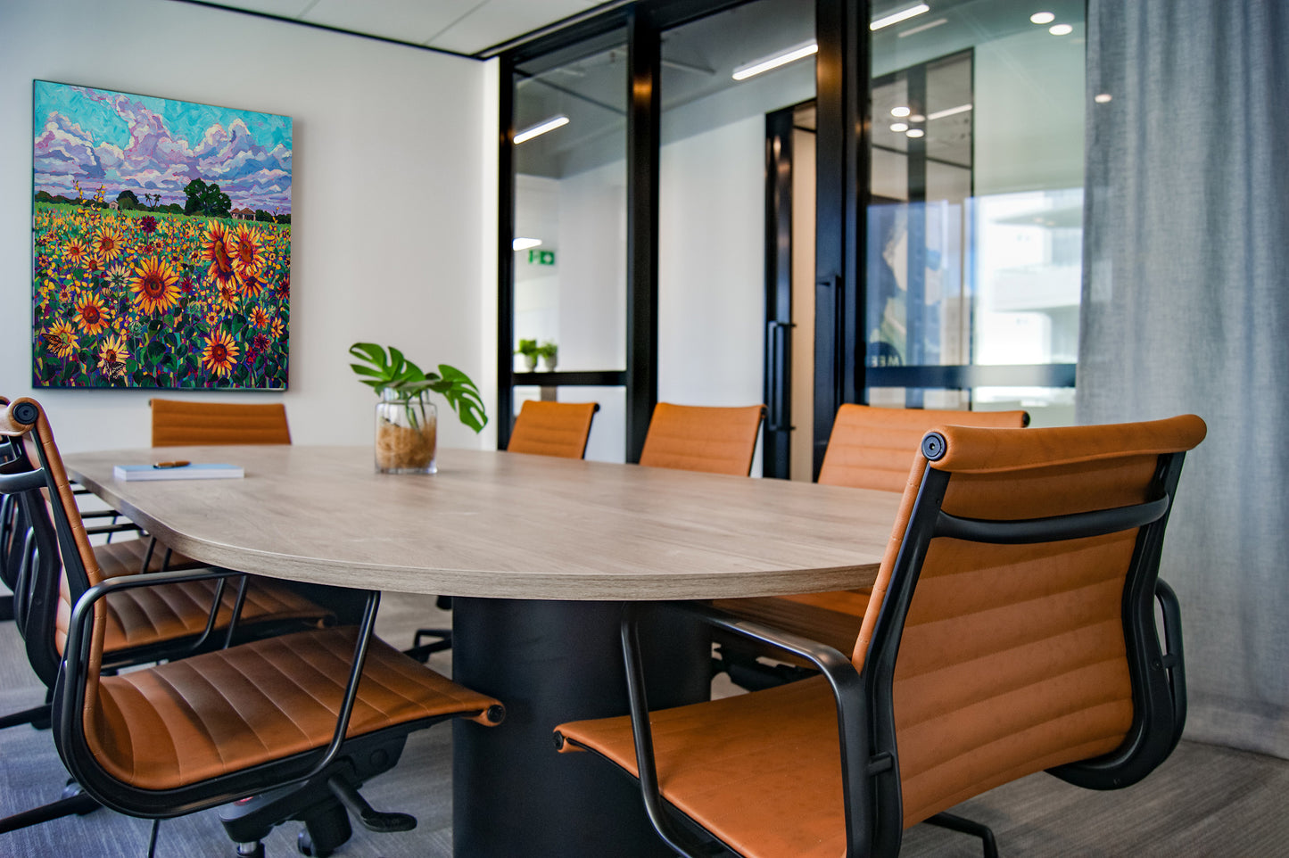 Original vibrant impressionistic painting of sunflowers in a field on wall of office conference room