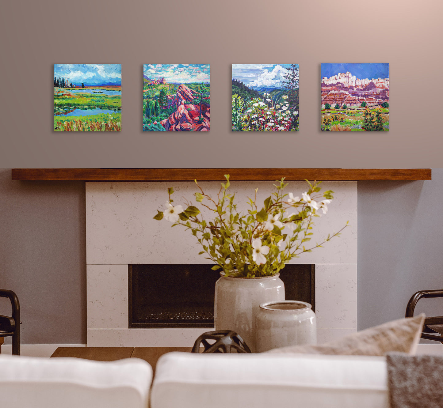 four landscape paintings over fireplace