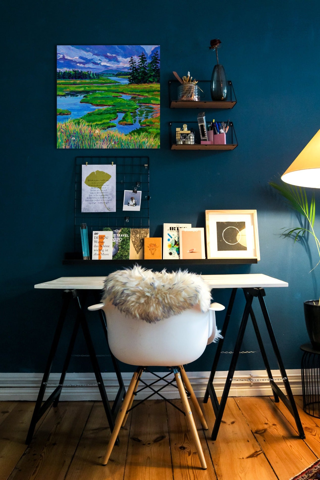 Painting hanging on wall in office with desk and shelves: 20x20 painterly original painting of Wetlands on Mount Desert Island Maine with dramatic sky and evergreen trees.