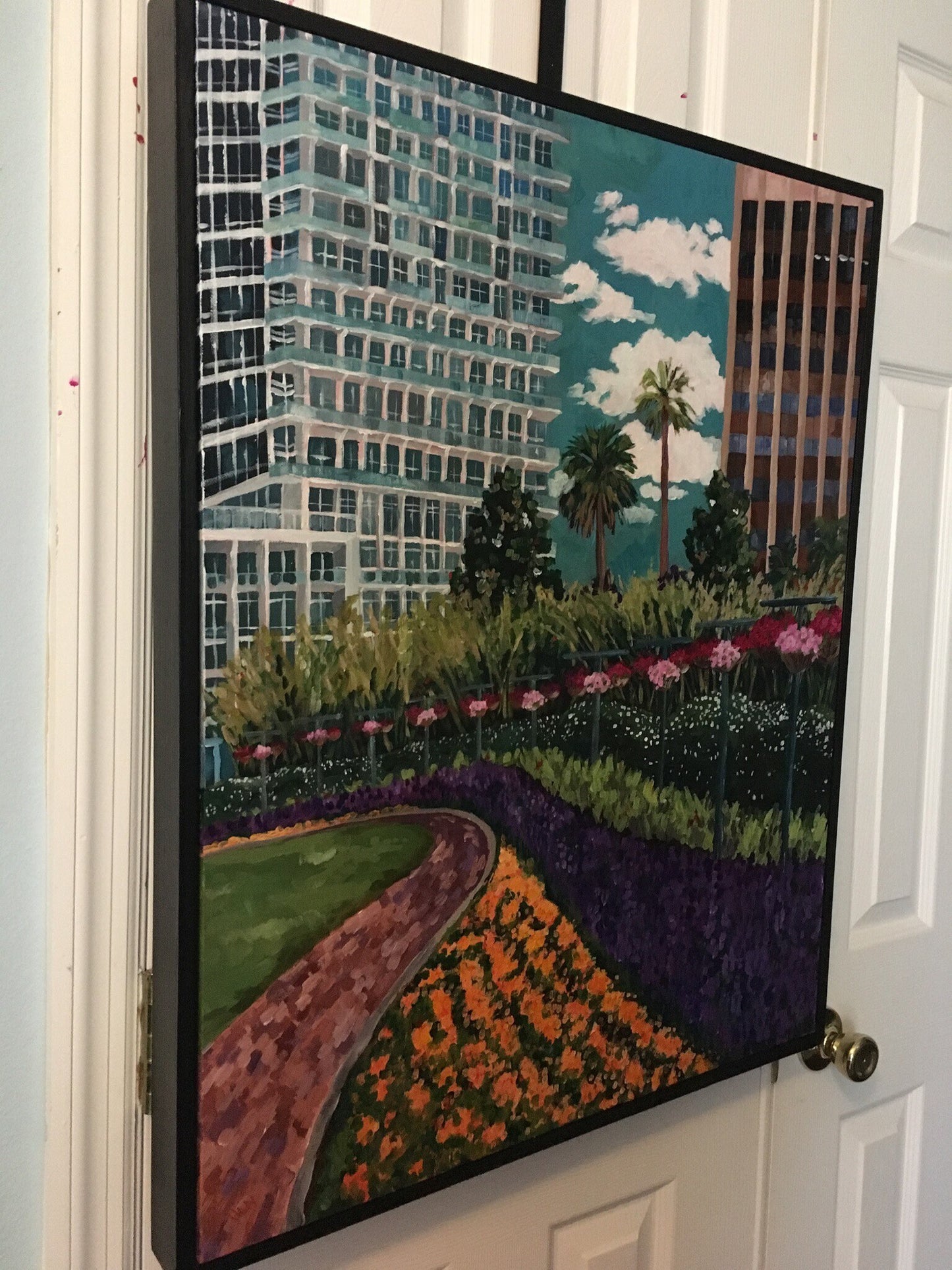 Original vibrant impressionistic painting of downtown Orlando hanging on the wall with floating frame
