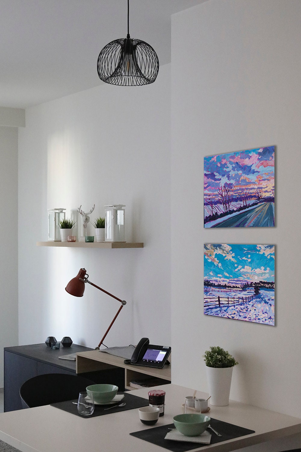 two vibrant small paintings over kitchen table