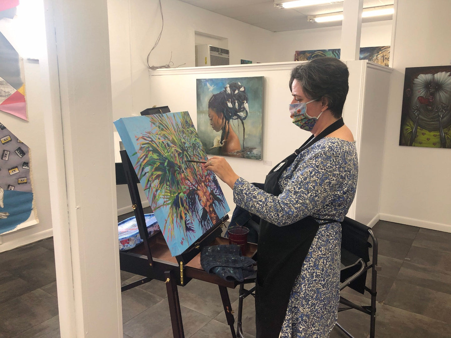 artist Heather Nagy working in friends gallery to demonstrate painting of date palm