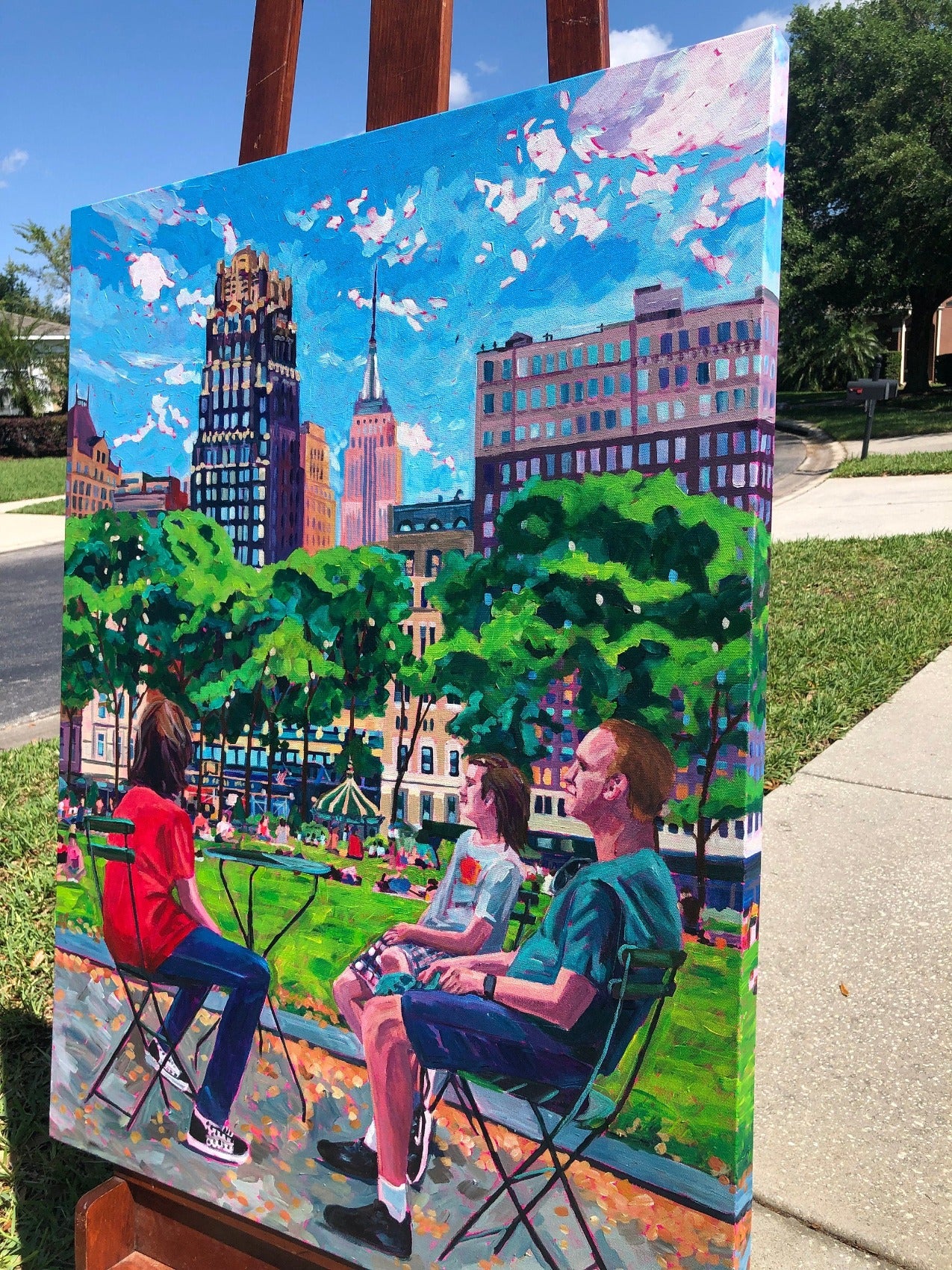 detail of painting outside on easel of NYC featuring Bryant Park in Summer