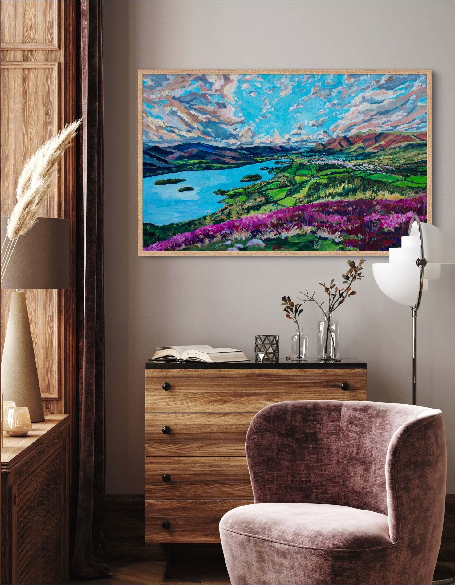 Room with rustic cabin feel but also modern touches with lamp, has dresser and pink chair and a landscape of the English lake District in a painterly vibrant idealized reality style.