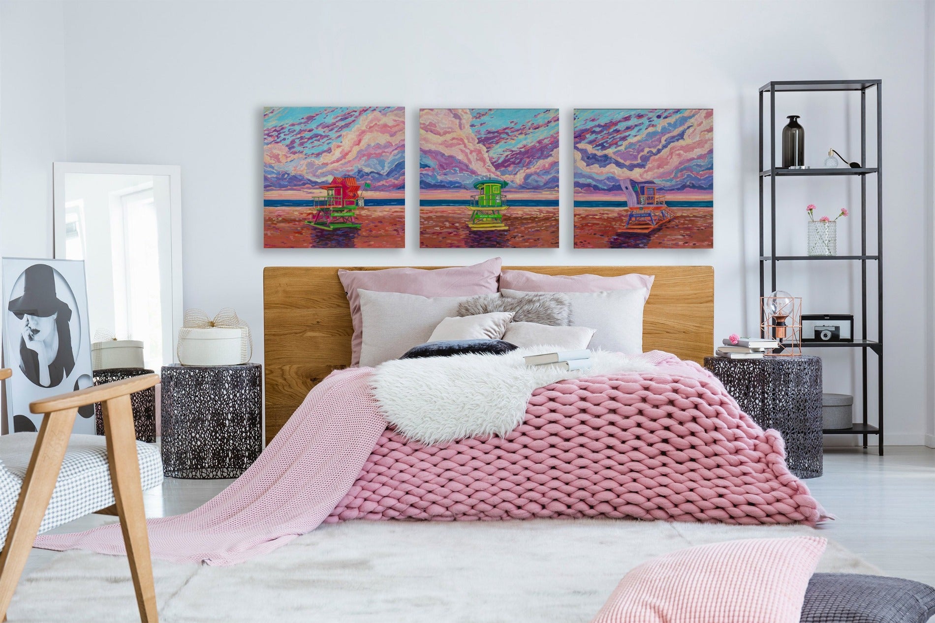 Bedroom with three sunrise beach paintings of quirky lifegaurd stands in South Beach Miami