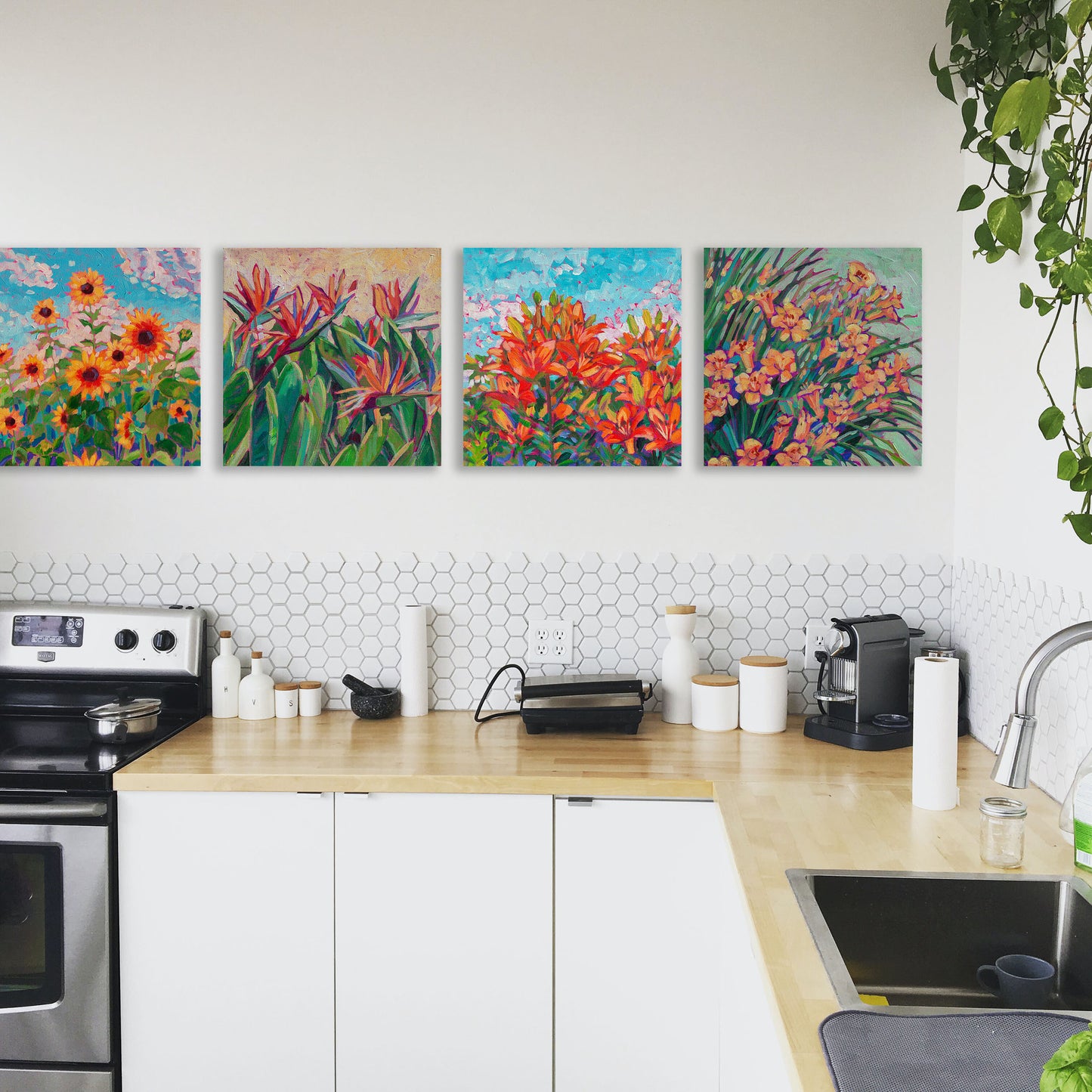 4 floral paintings in white kitchen