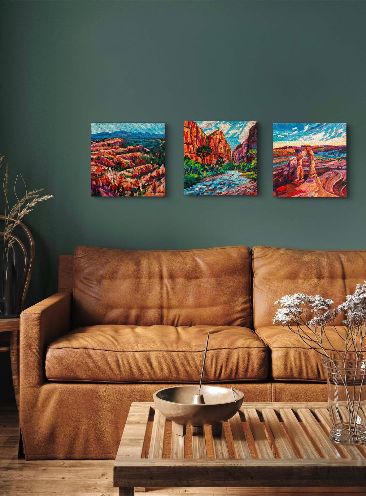 living room with brown leather couch and coffee table with three modern landscapes of the southwest united states.
