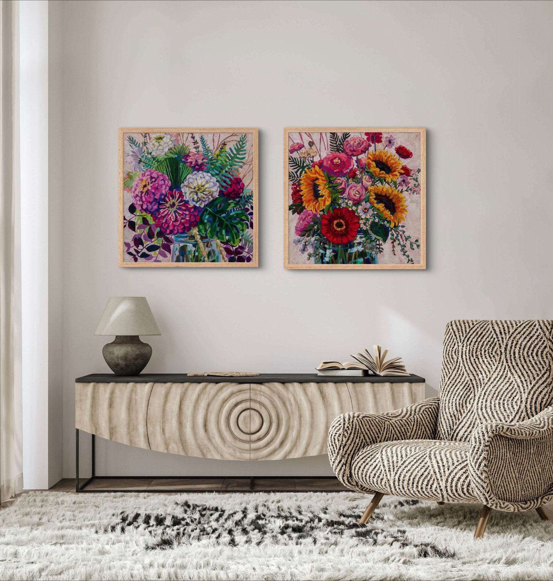 two vibrant floral still life paintings by modern impressionist artist Heather Nagy in a neutral room with wood side table, chair and thick cream rug.