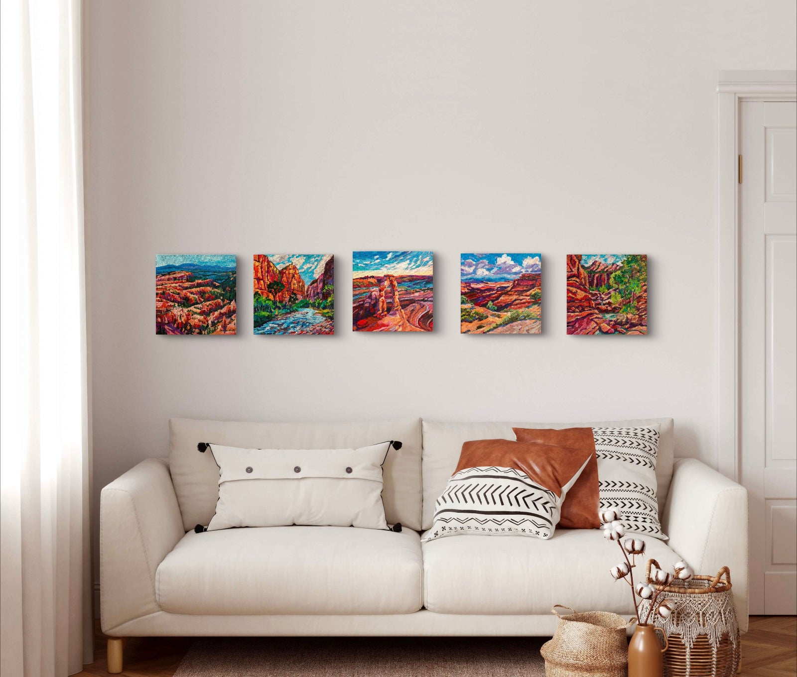 Five colorful vibrant modern impressionist landscape paintings of Southwest National Parks on wall in front of cream couch