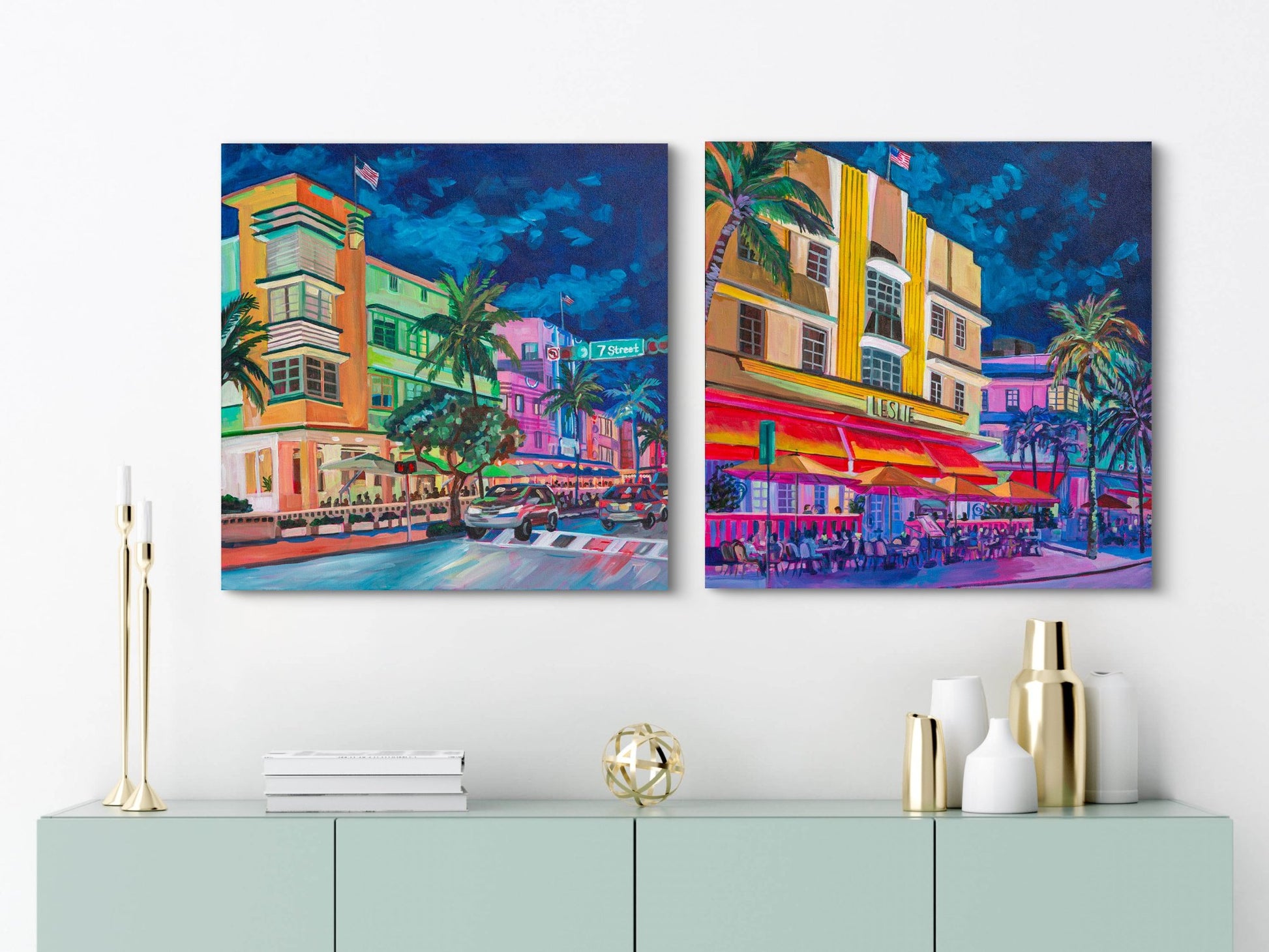 two square Miami beach night street scenes of iconic art deco hotels brightly lite on white wall with modern credenza underneath