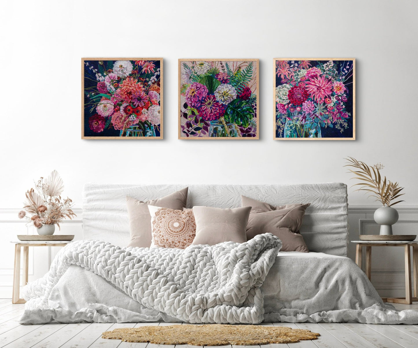 Neutral airy but cozy bedroom  with two side tables with dried plants and three amazing statement piece floral still life paintings by artist Heather Nagy