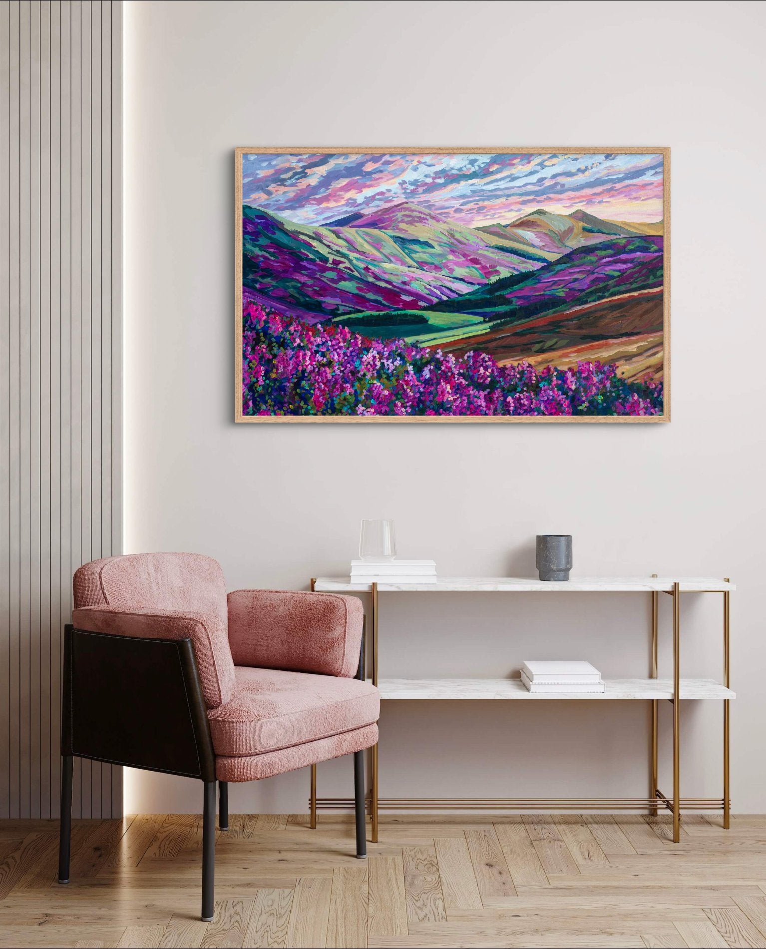 Heather in the Hills, West Linton-Scotland, landscape painting of Scotland with mountains and purple pink flowers on wall with a shelf and pink chair.