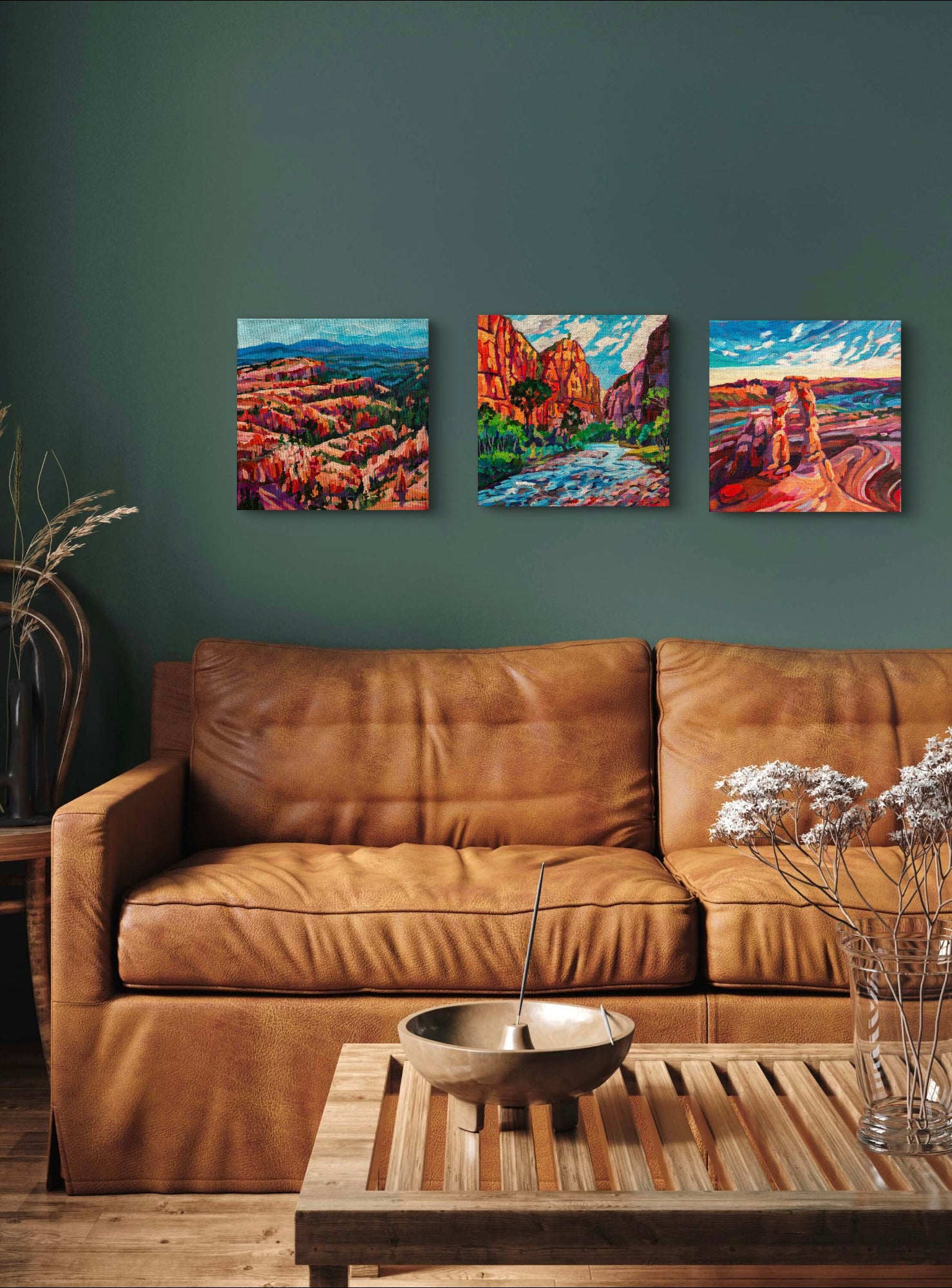 living room with brown leather couch and coffee table with three modern landscapes of the southwest united states.