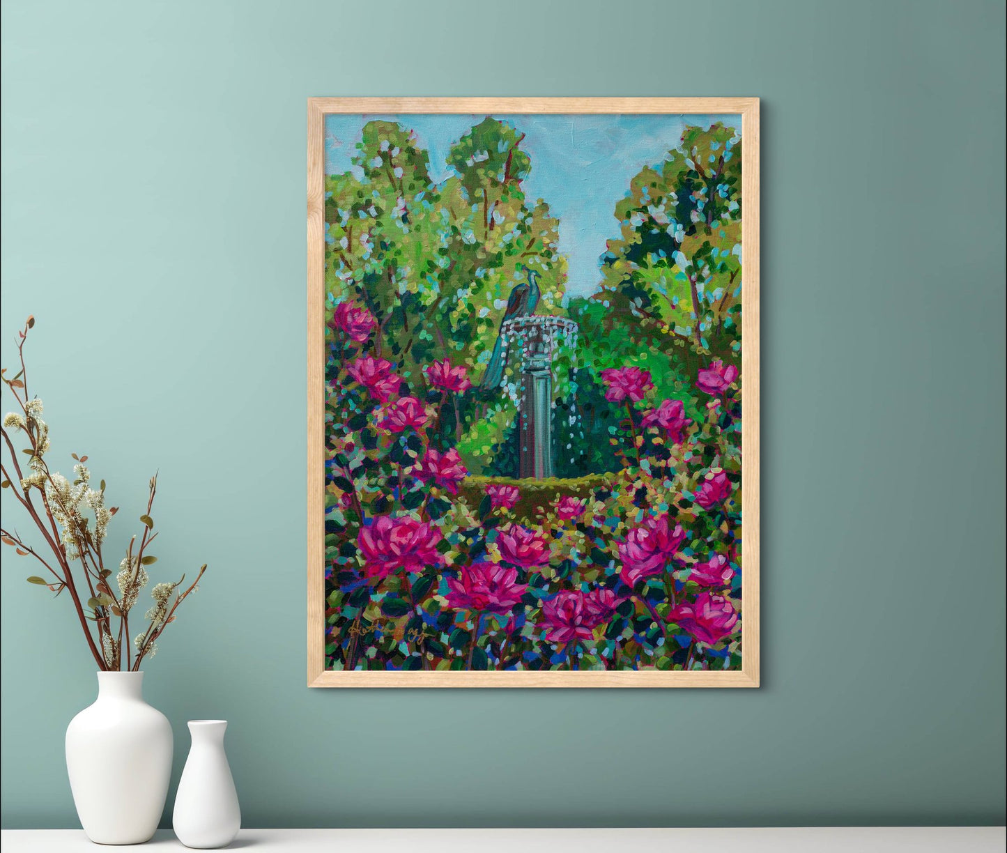 cheerful garden painting on teal wall above shelf with white vases.