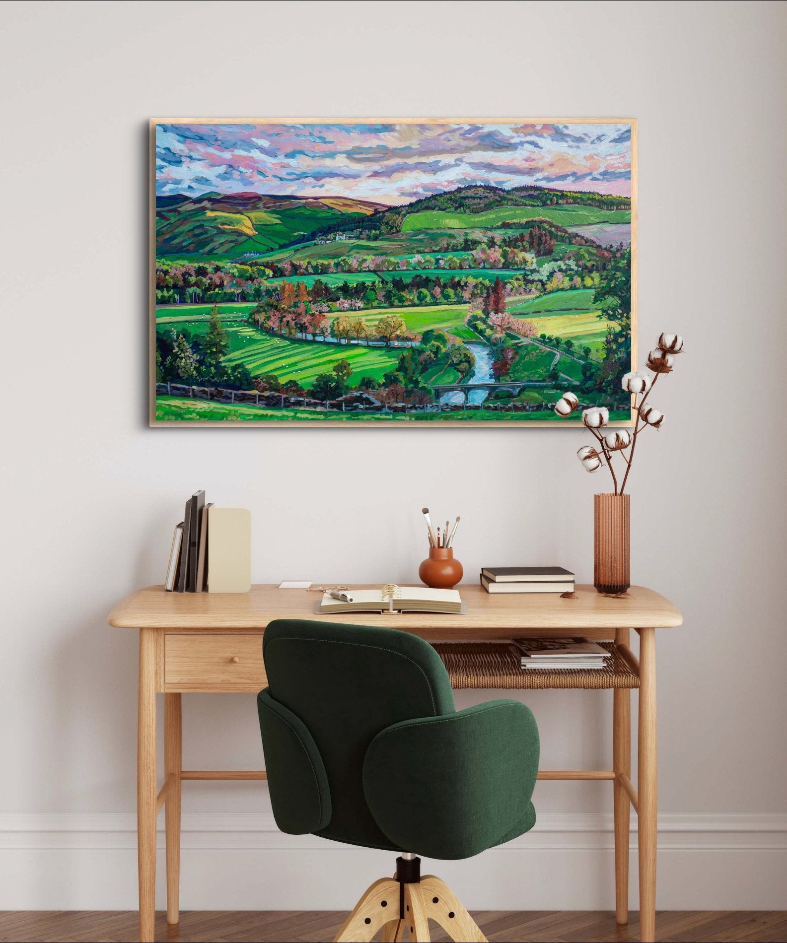 Small wood desk in bright room with green office chair on wall is serene inspirational landscape in shades of greens.