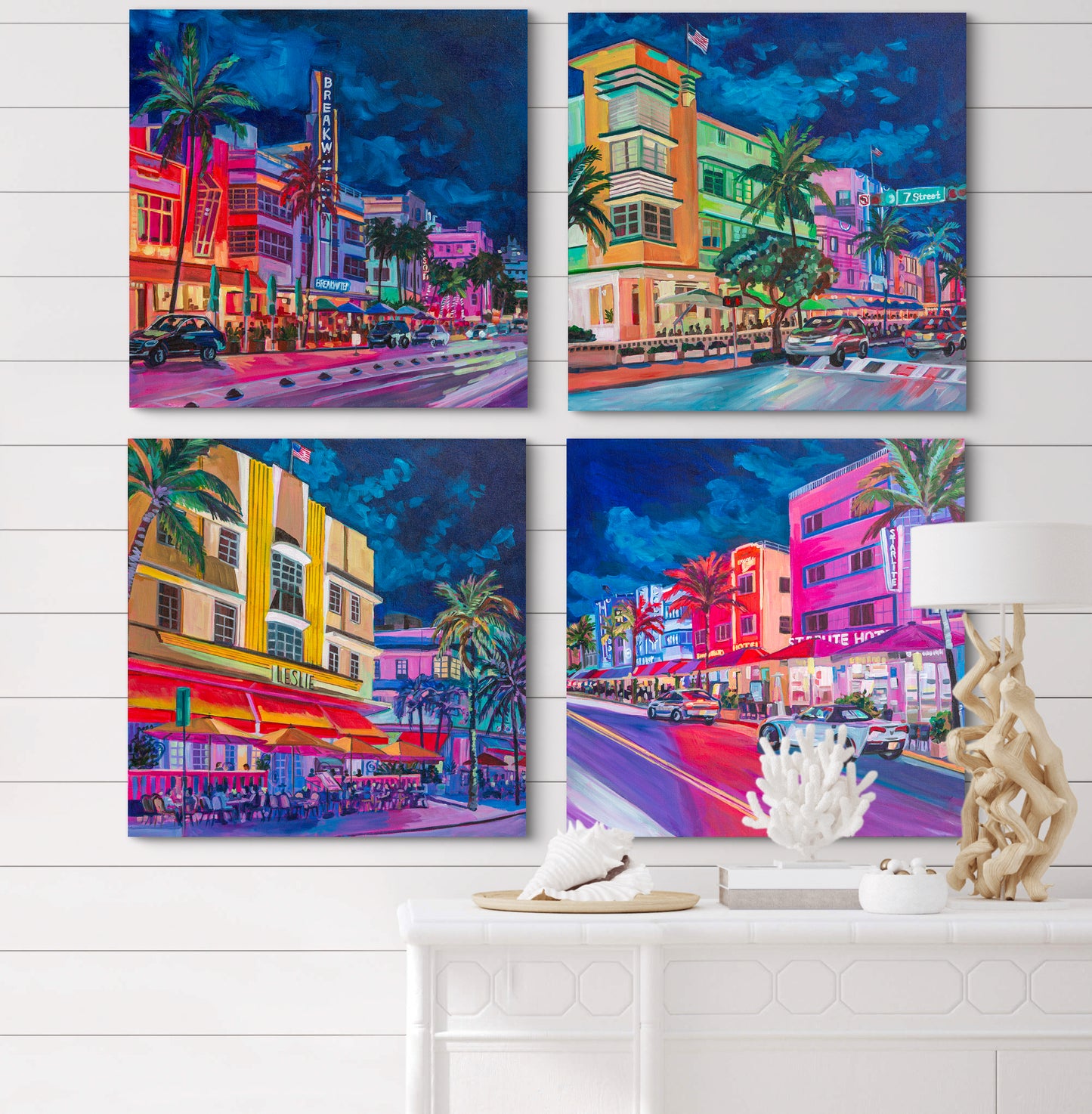 4 bright night street city scenes on wall of white room with coastal decor