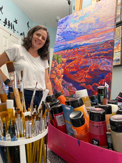 Artist Heather Nagy in studio space with painting and supplies