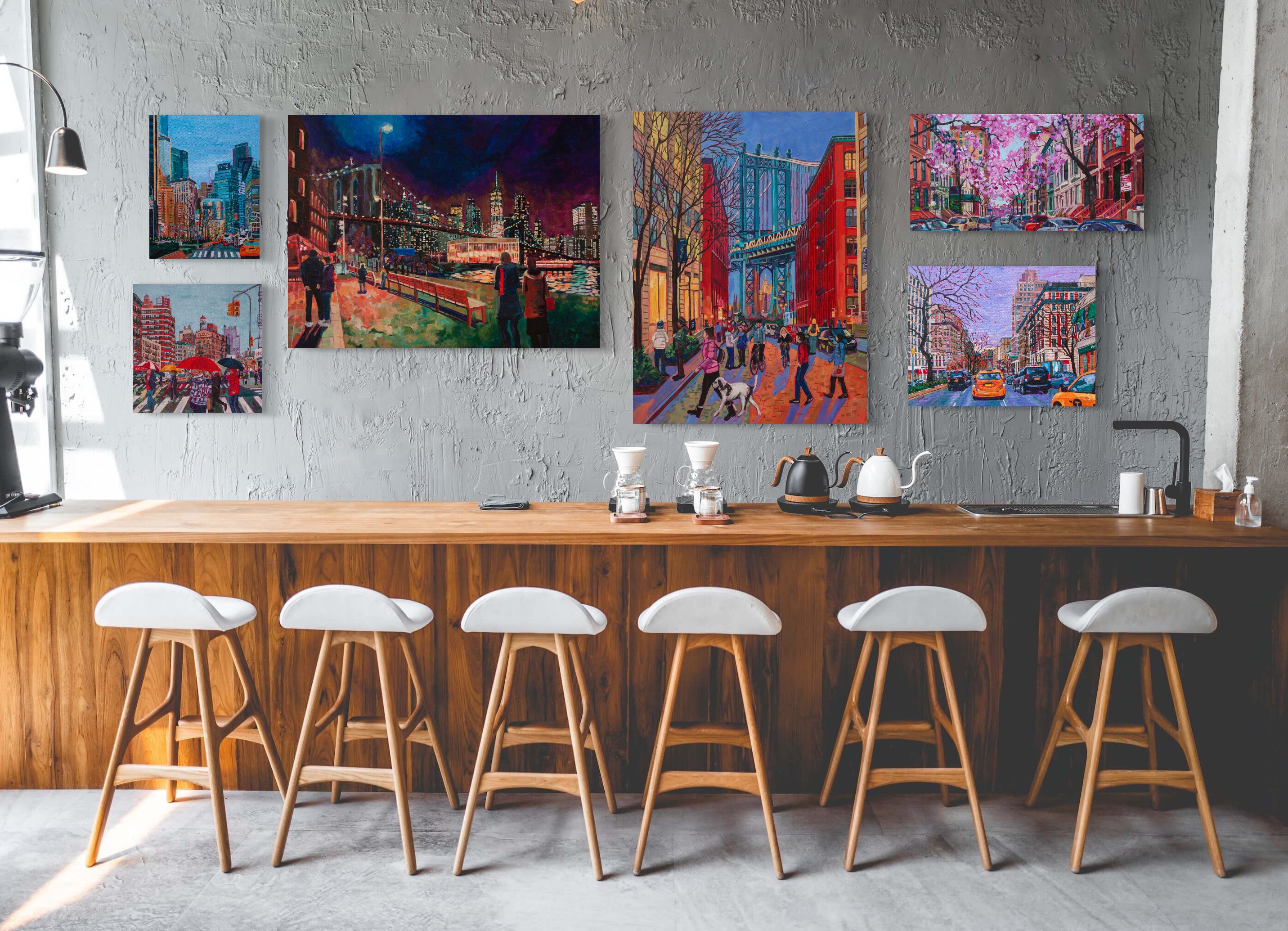 Bar or kitchen setting with stools with collection of 6 different New York City paintings on the wall.