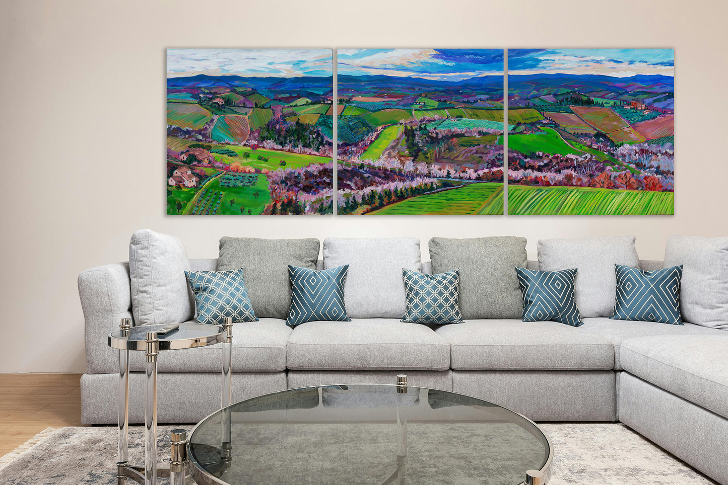 living room with large three panel painting of rolling farmland hills of Tuscany