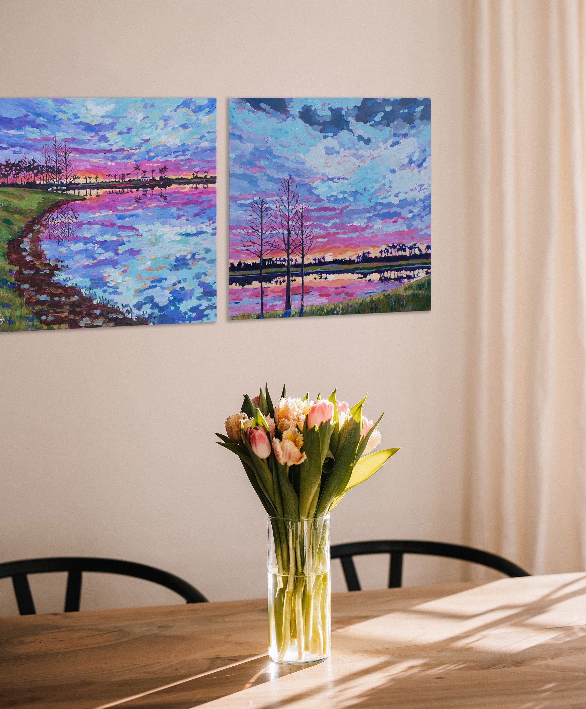 two paintings on wall with kitchen table