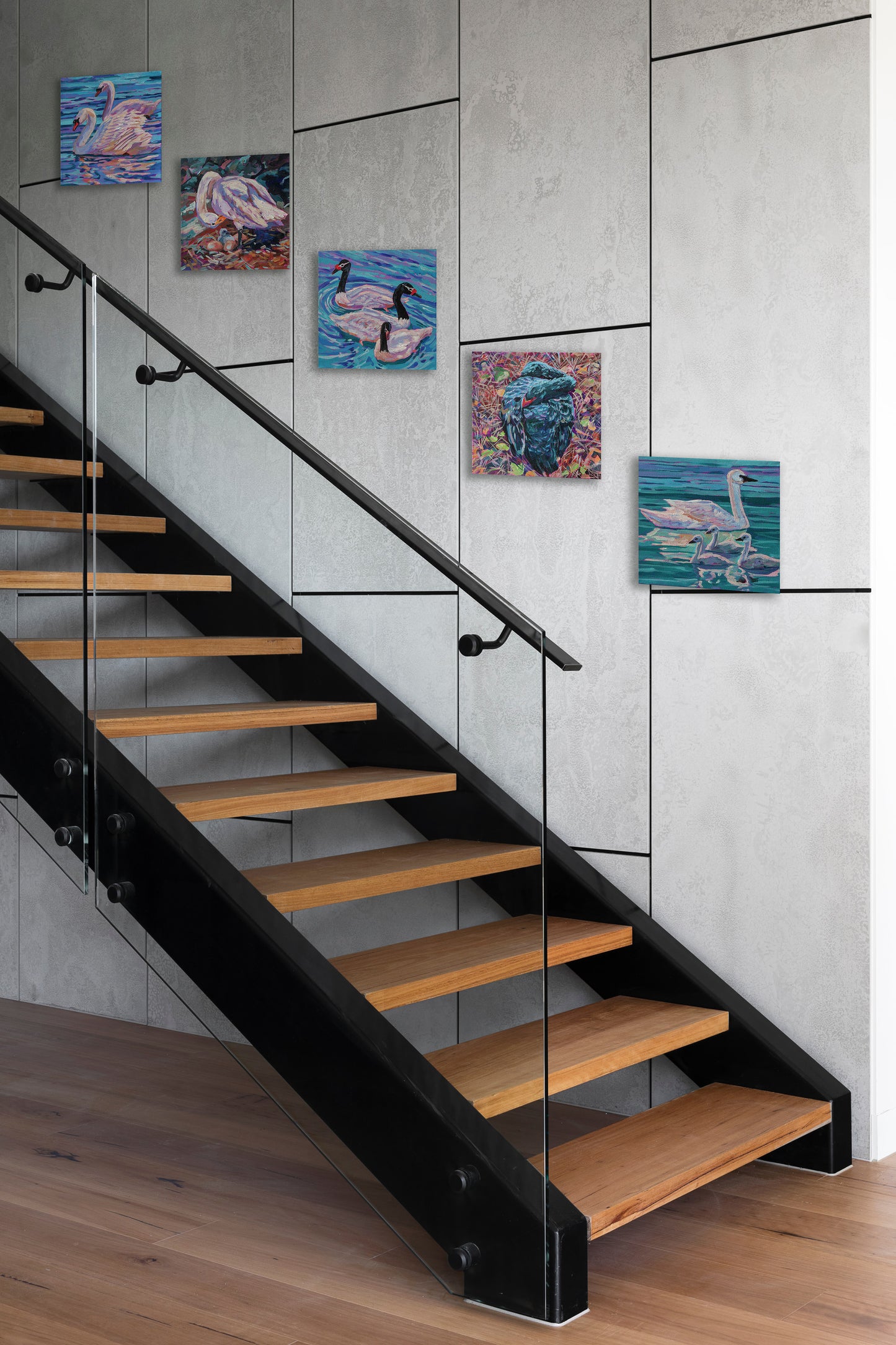 swan paintings on wall with staircase
