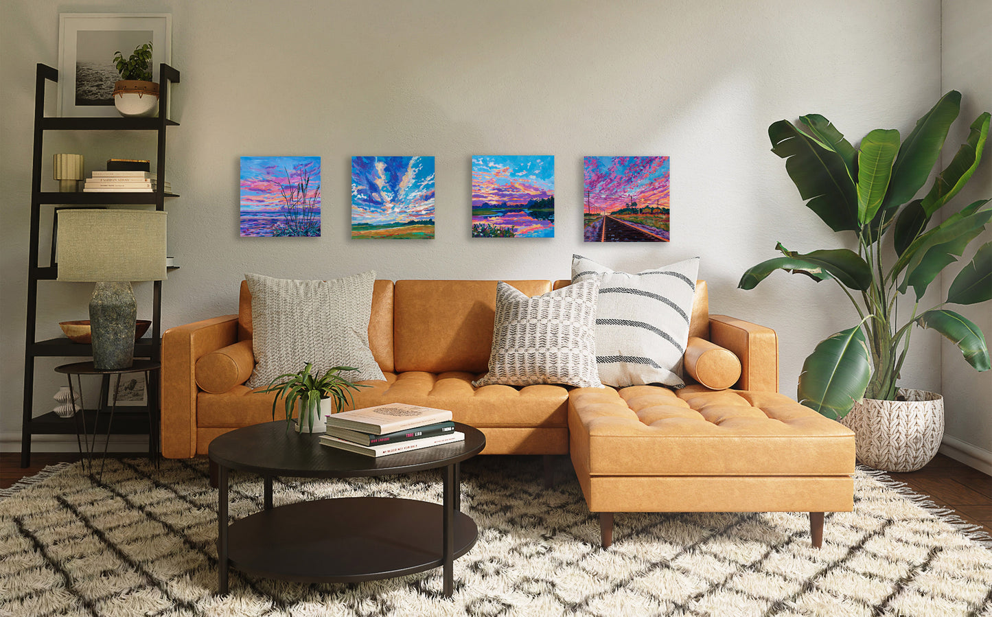 four dramatic sunset paintings hung in living room