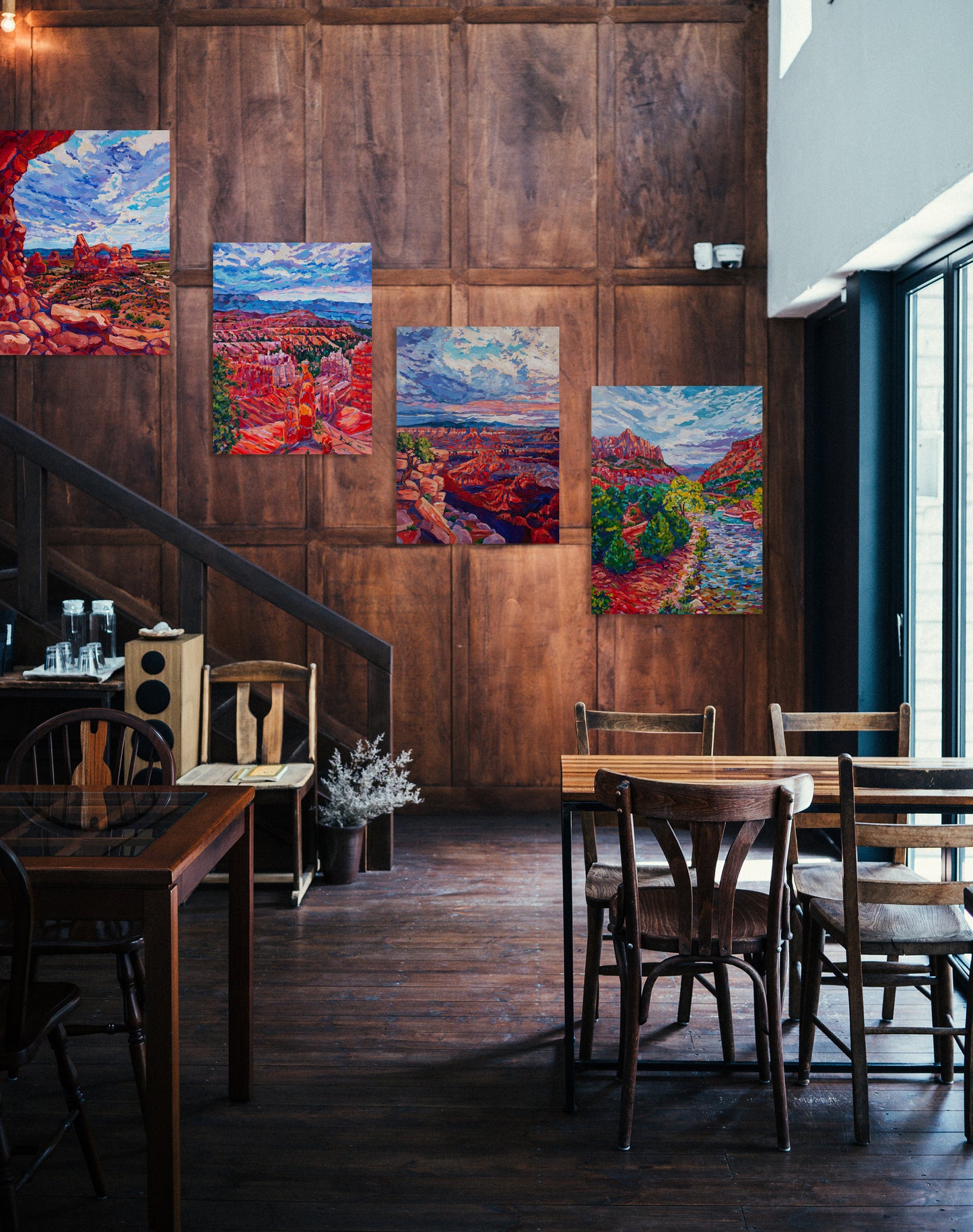 4 large paintings of Utah's National Parks on wall of a cafe space