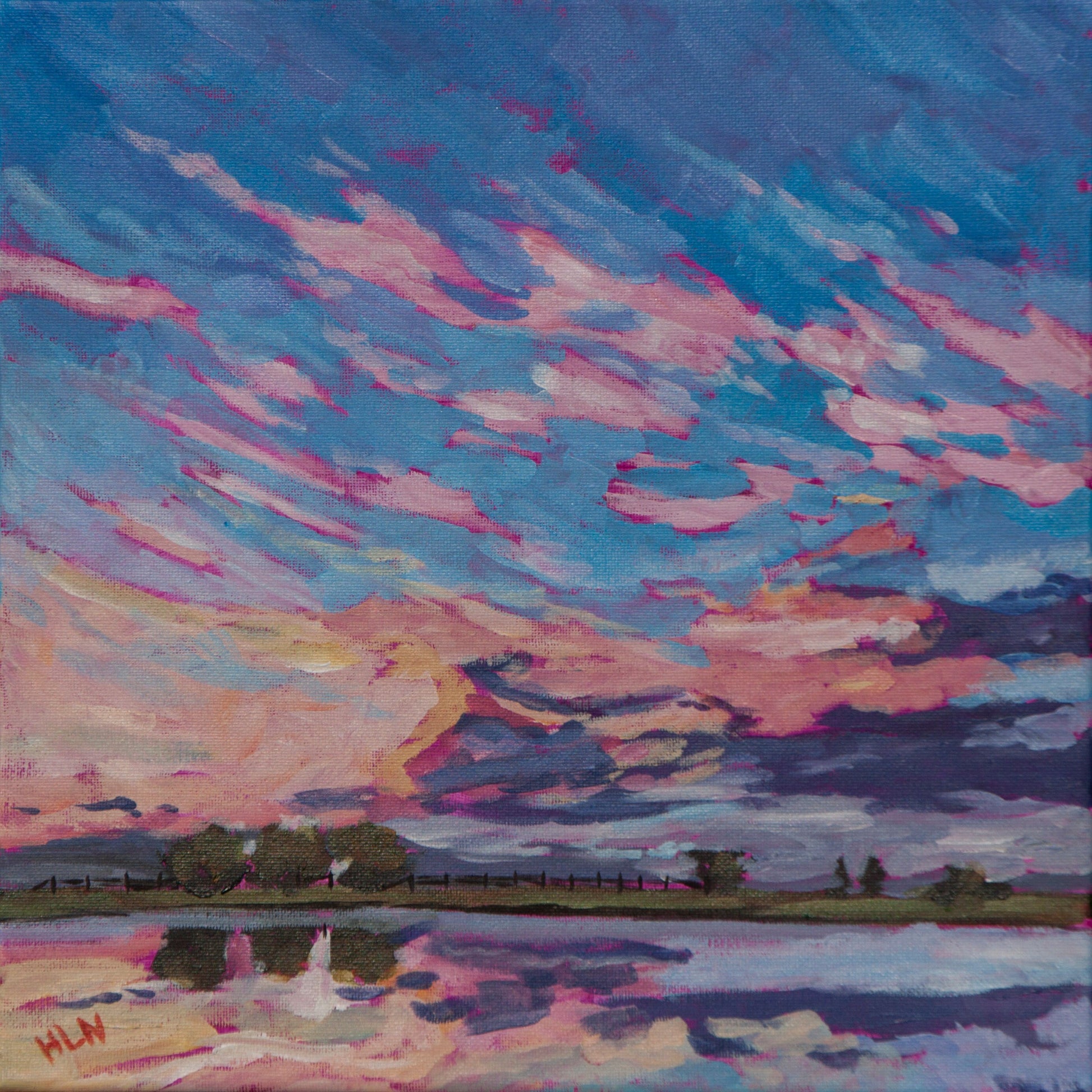 sunrise painting over water with dramatic skies