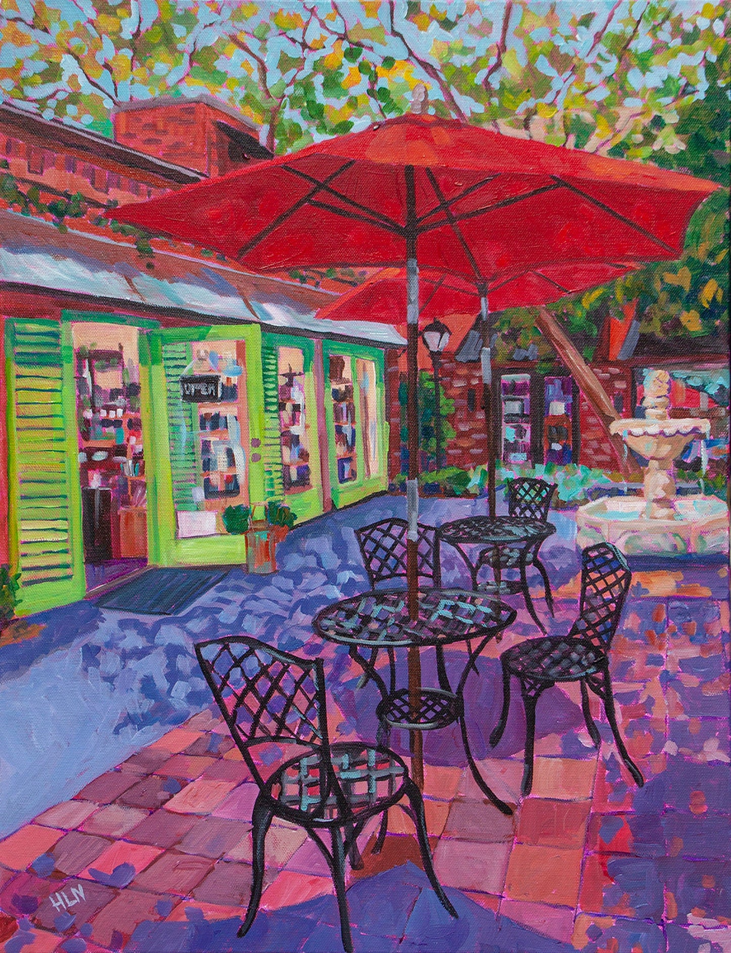 Hidden Courtyard with tables, umbrellas, fountain and the Ancient Olive store in Winter Park Florida