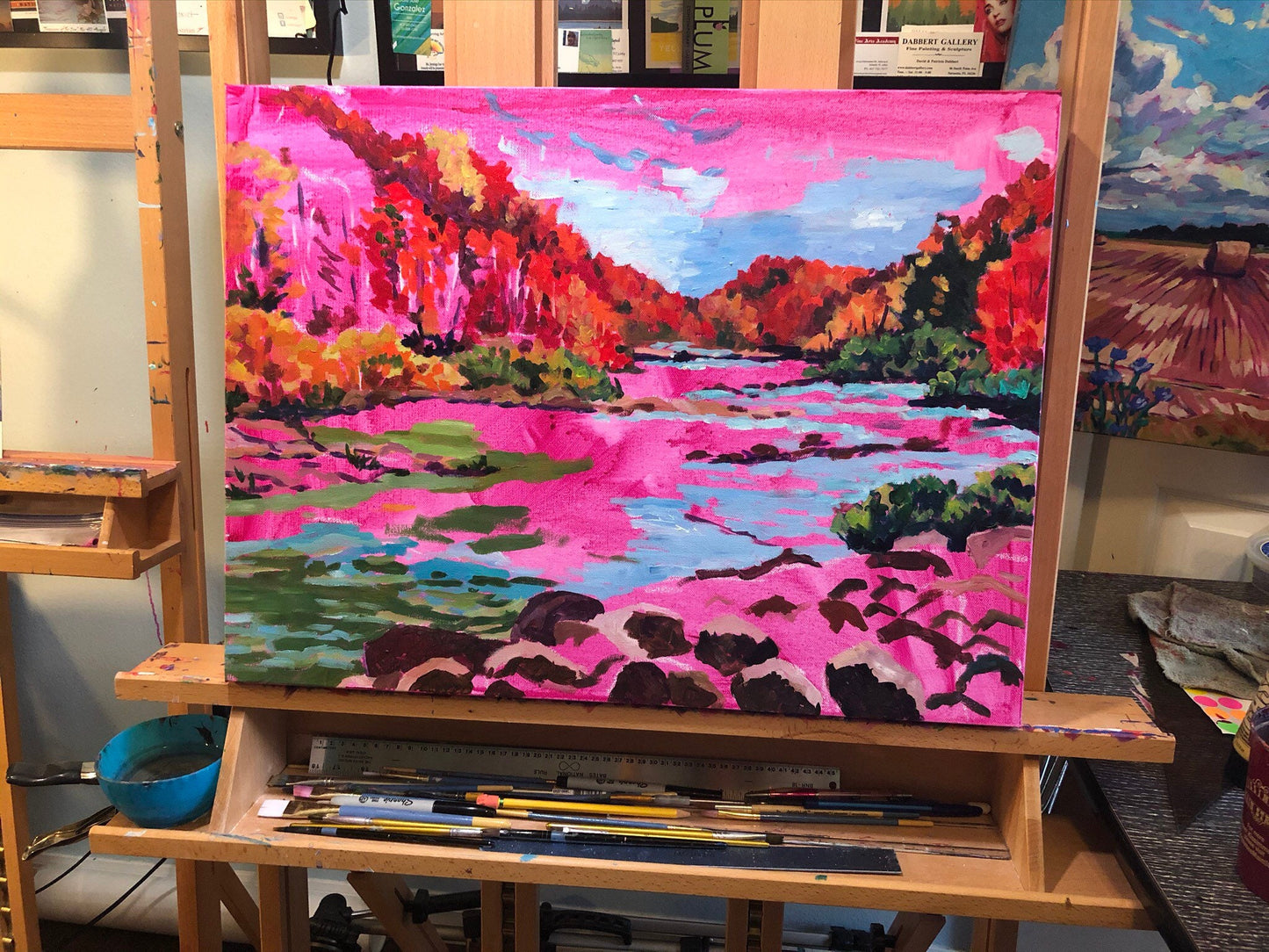 painting in progress in artist studio on easel with magenta wash