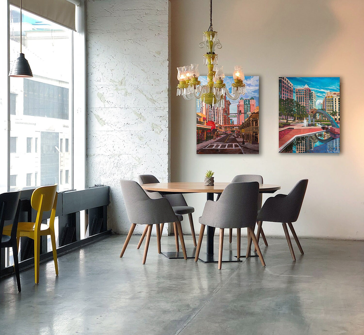 two paintings of downtown orlando florida in an high rise dining area