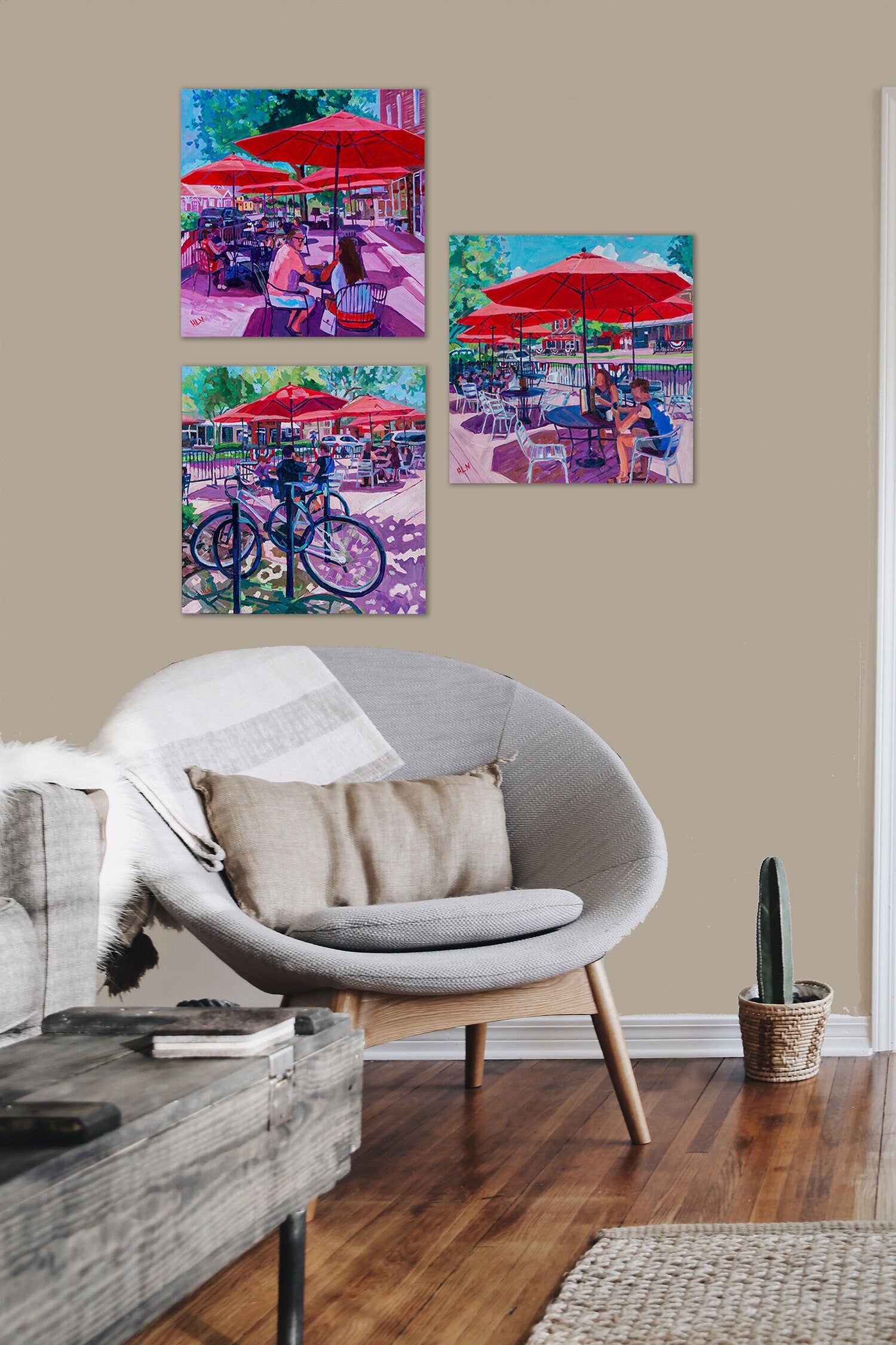 Trio of paintings all of Winter Garden Florida on wall of neutral living room area with chair