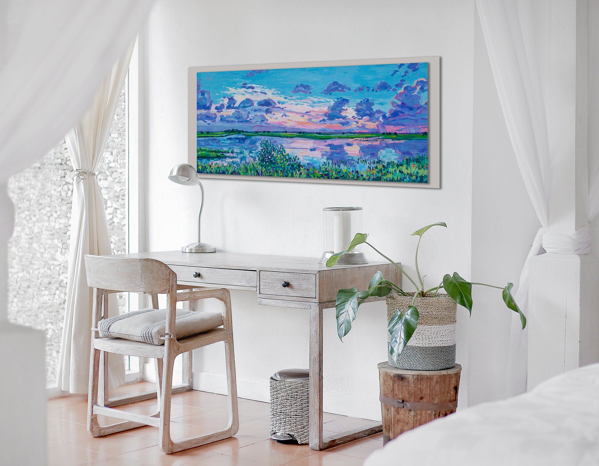 St Augustine marshland sunset painting on wall behind desk in a white and neutral bedroom