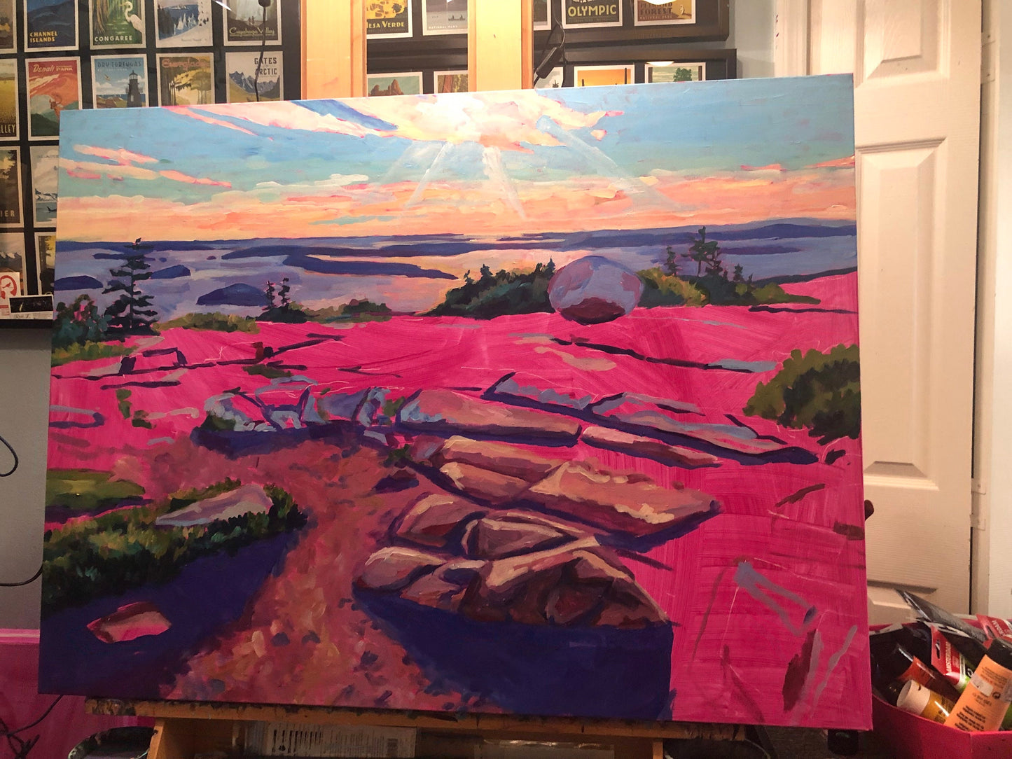Painting in studio in progress with magenta undercoat of Cadillac Summit sunrise