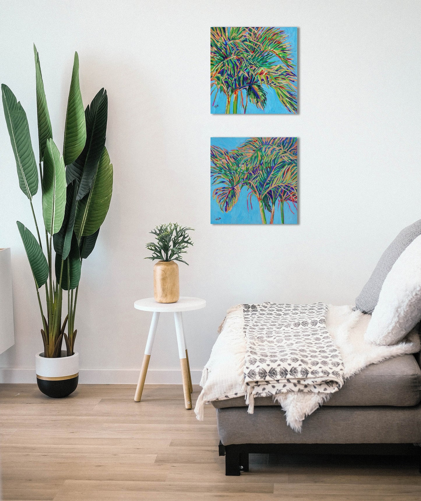 two Christmas tree palm paintings in living room setting