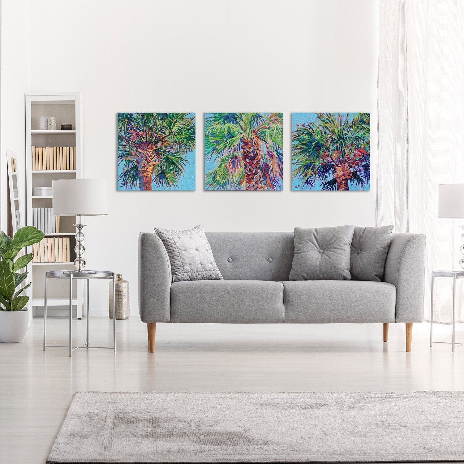 three cabbage palm tree paintings in bright living room setting