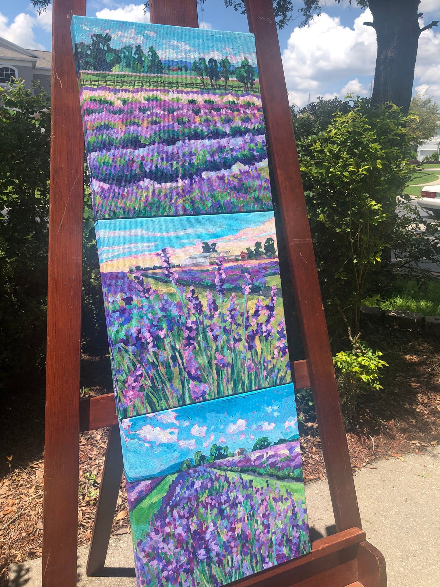 3 lavender field paintings on easel outside