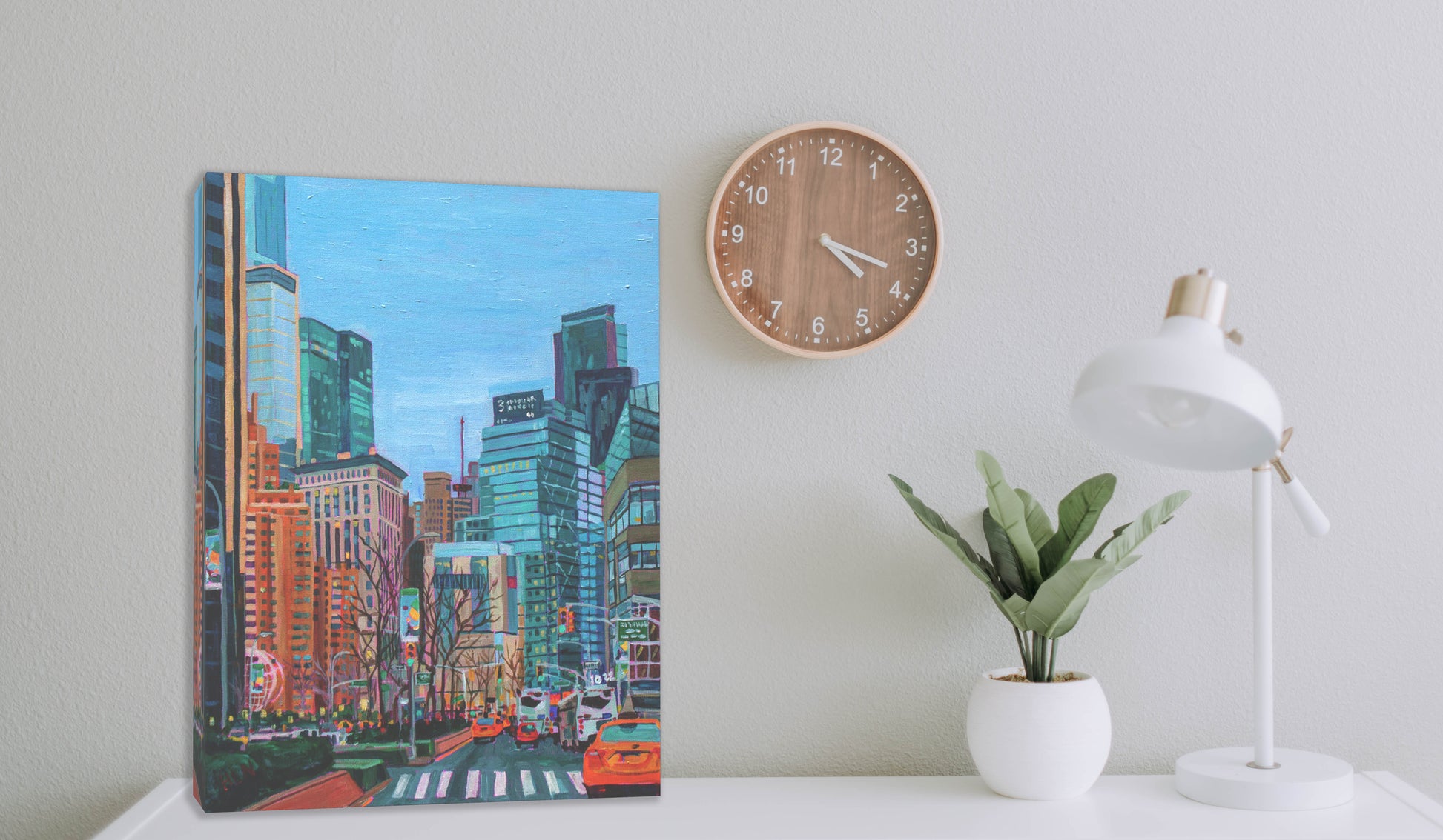 New York City painting on dresser with clock and lamp